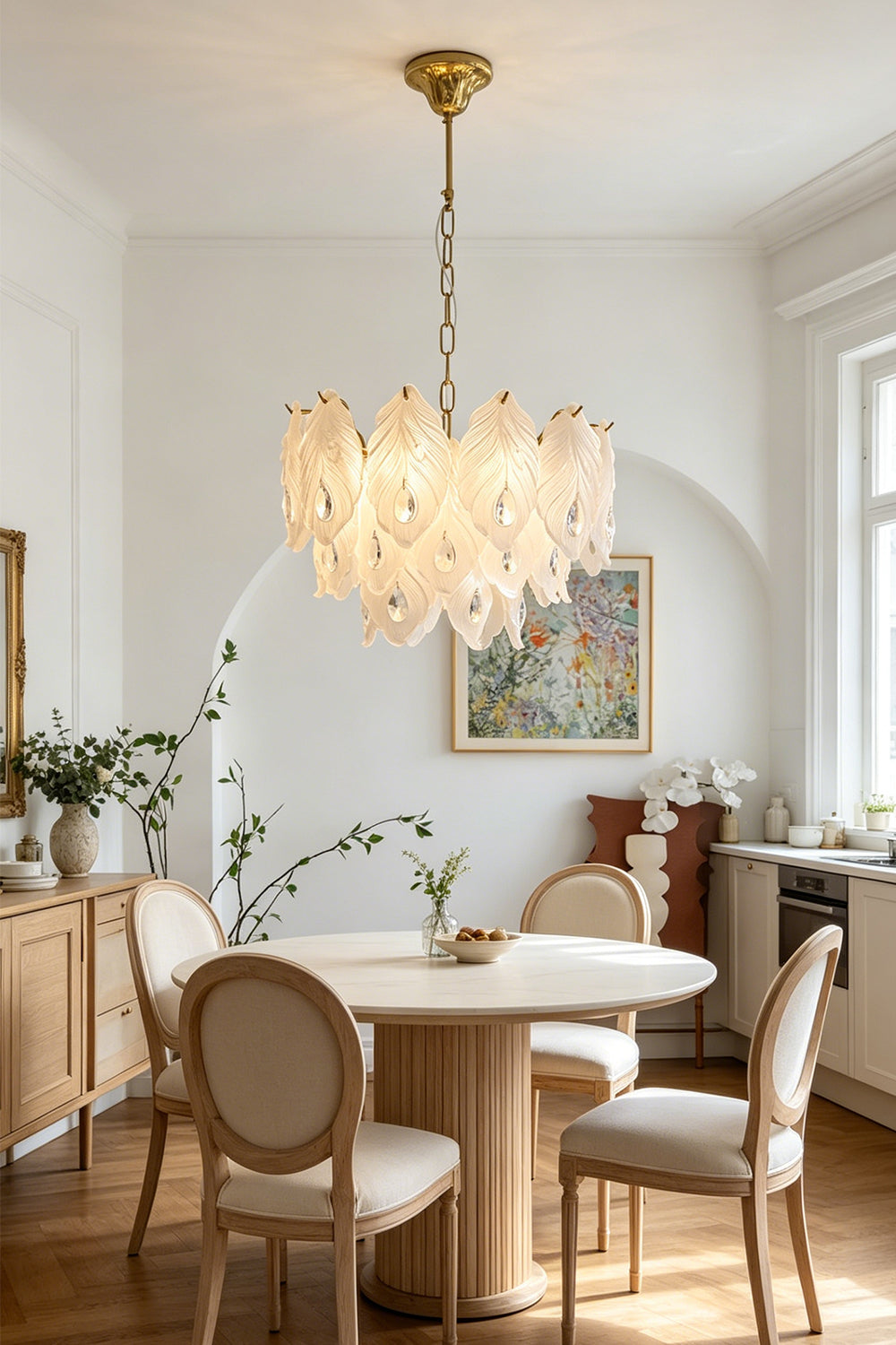 Pluma Frosted Glass Feather Chandelier | Glass, Metal | Hanging as a luxurious centerpiece over a round wooden dining table with round-back chairs in a bright classical room | Samu Lamp
