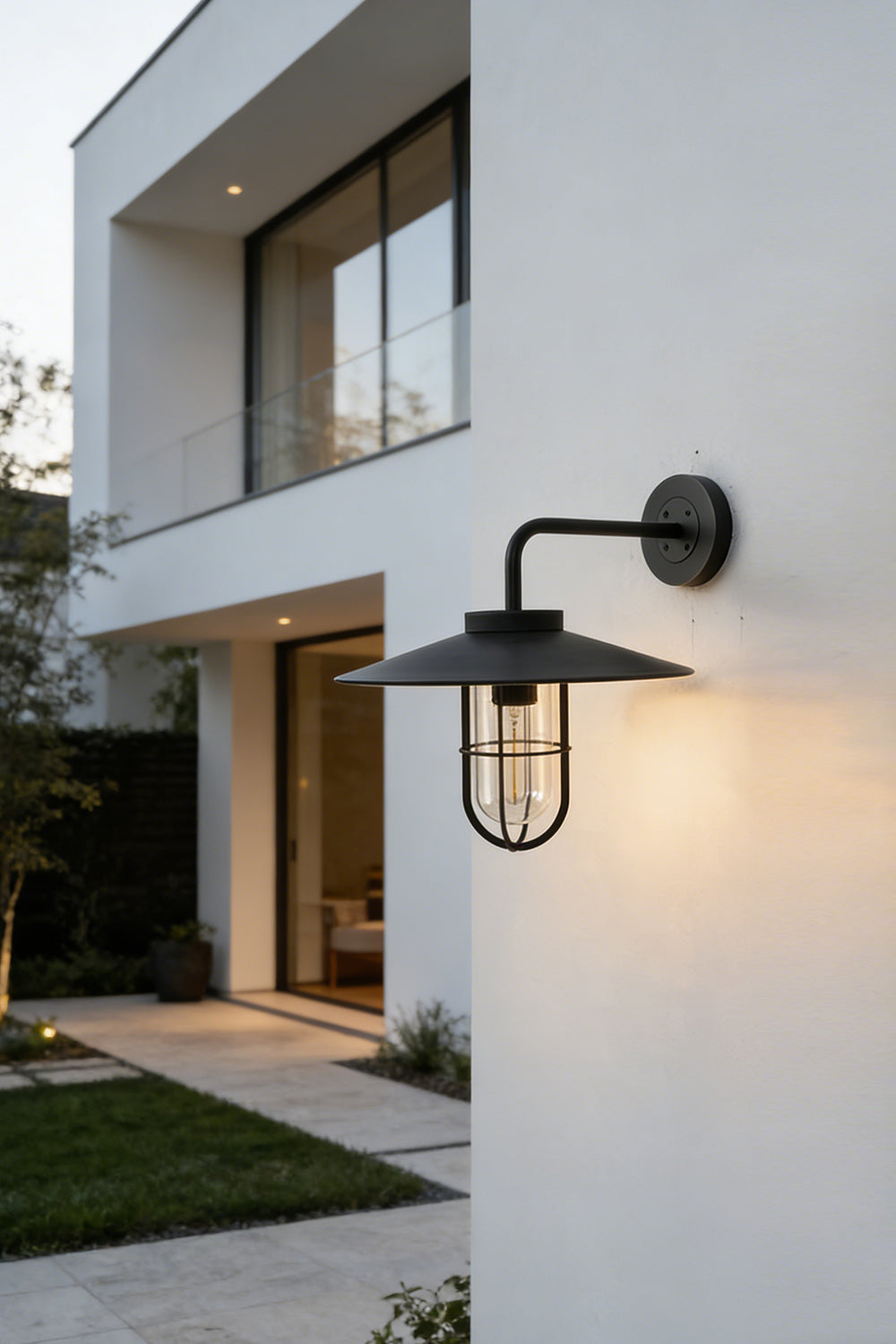 Portree wall light in black finish on modern exterior wall | Metal, Glass | Outdoor lighting scene at a contemporary house | Samu Lamp