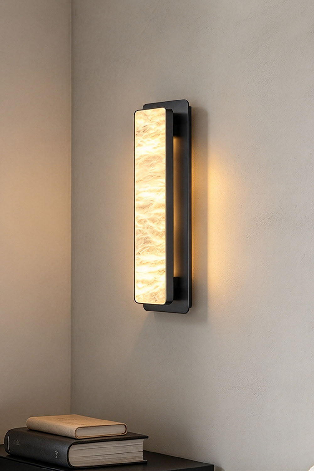 Quadrelle Wall Sconce | Alabaster and Bronze | Corner wall installation illuminated above a bookshelf nook | Samu Lamp