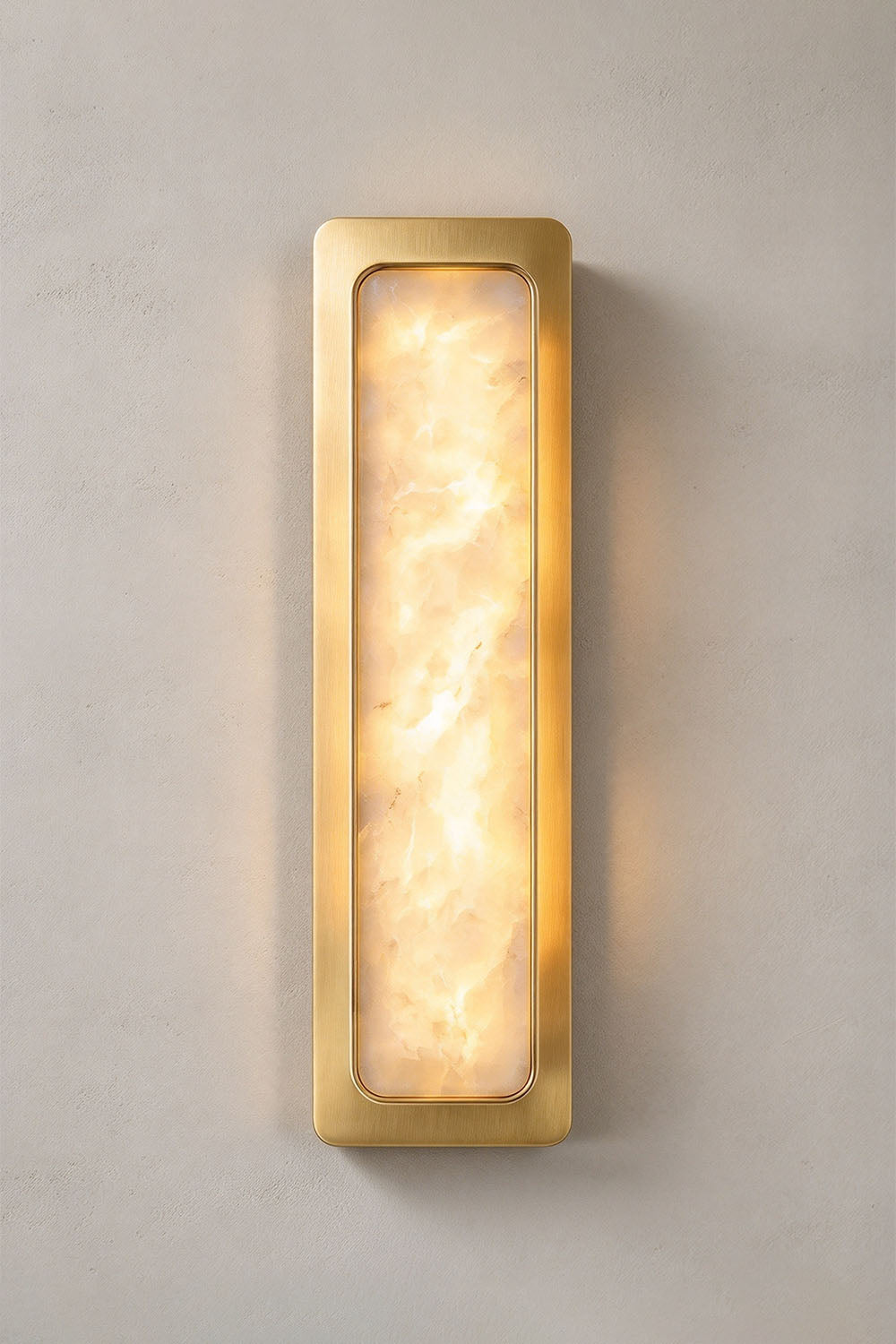 Quadrelle Wall Sconce | Alabaster and Brass | Straight front view illuminated on neutral beige wall | Samu Lamp