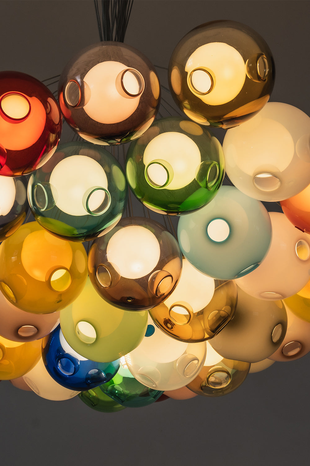Rainbow Glass Bubble Cluster Chandelier | Glass, Metal | Underneath perspective looking up into the dense cluster of multi-colored translucent glass spheres | Detail shot | Samu Lamp