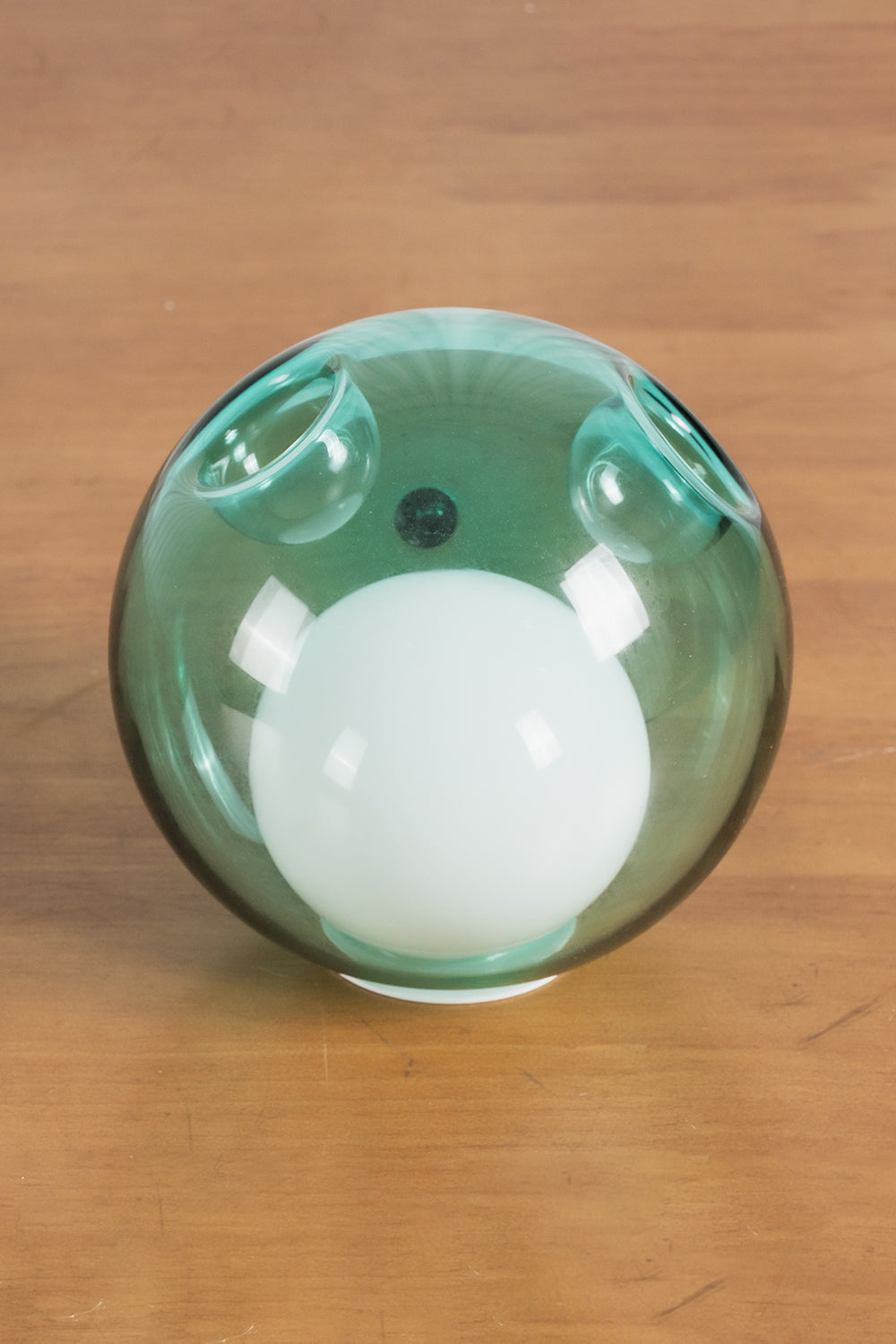 Rainbow Glass Bubble Cluster Chandelier | Glass, Metal | Detailed close-up shot of a single translucent green glass globe with an integrated white frosted core diffuser | Detail shot | Samu Lamp