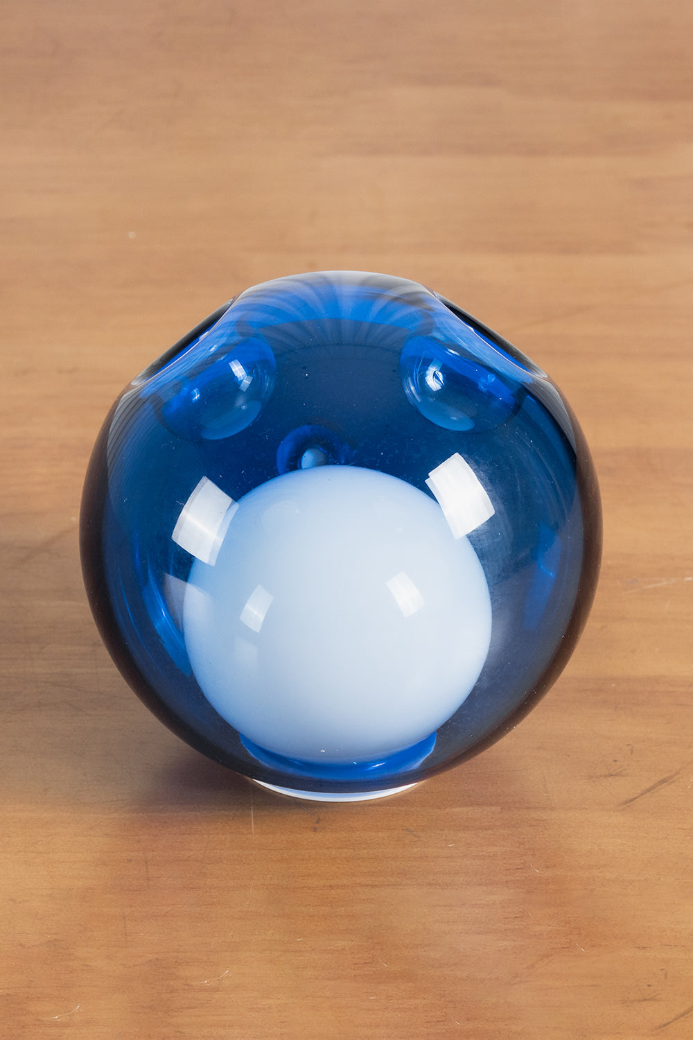 Rainbow Glass Bubble Cluster Chandelier | Glass, Metal | Detailed close-up shot of a single glossy dark blue glass globe with an internal frosted light core diffuser | Detail shot | Samu Lamp