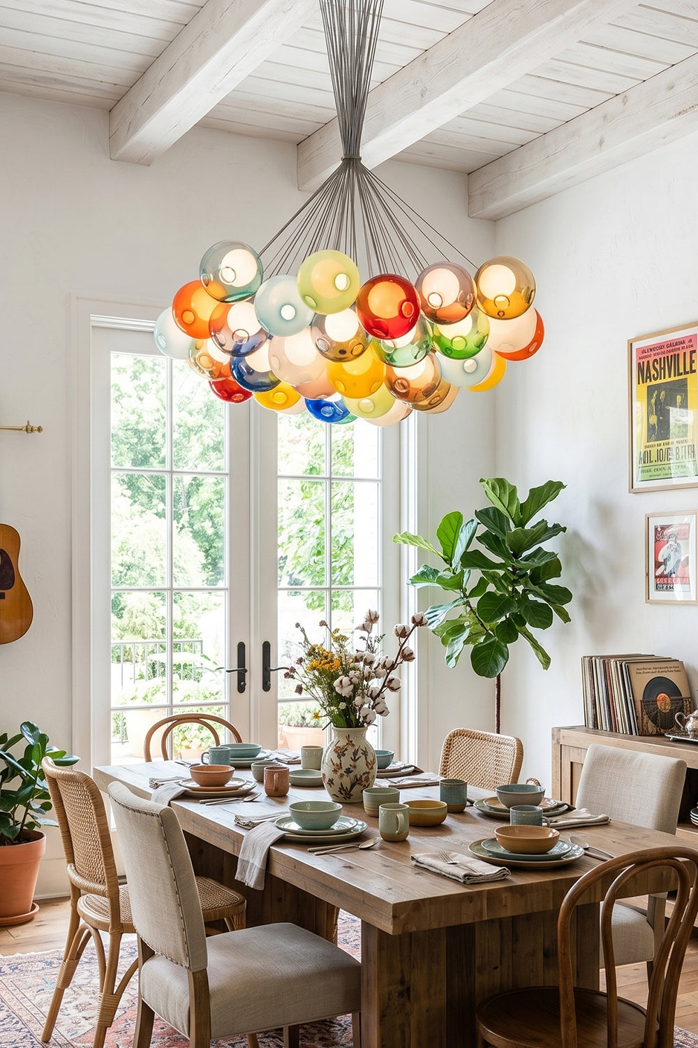 Rainbow Glass Bubble Cluster Chandelier | Glass, Metal | Suspended as a vibrant statement centerpiece above a wooden dining table in a bright rustic dining room facing open garden doors | Samu Lamp
