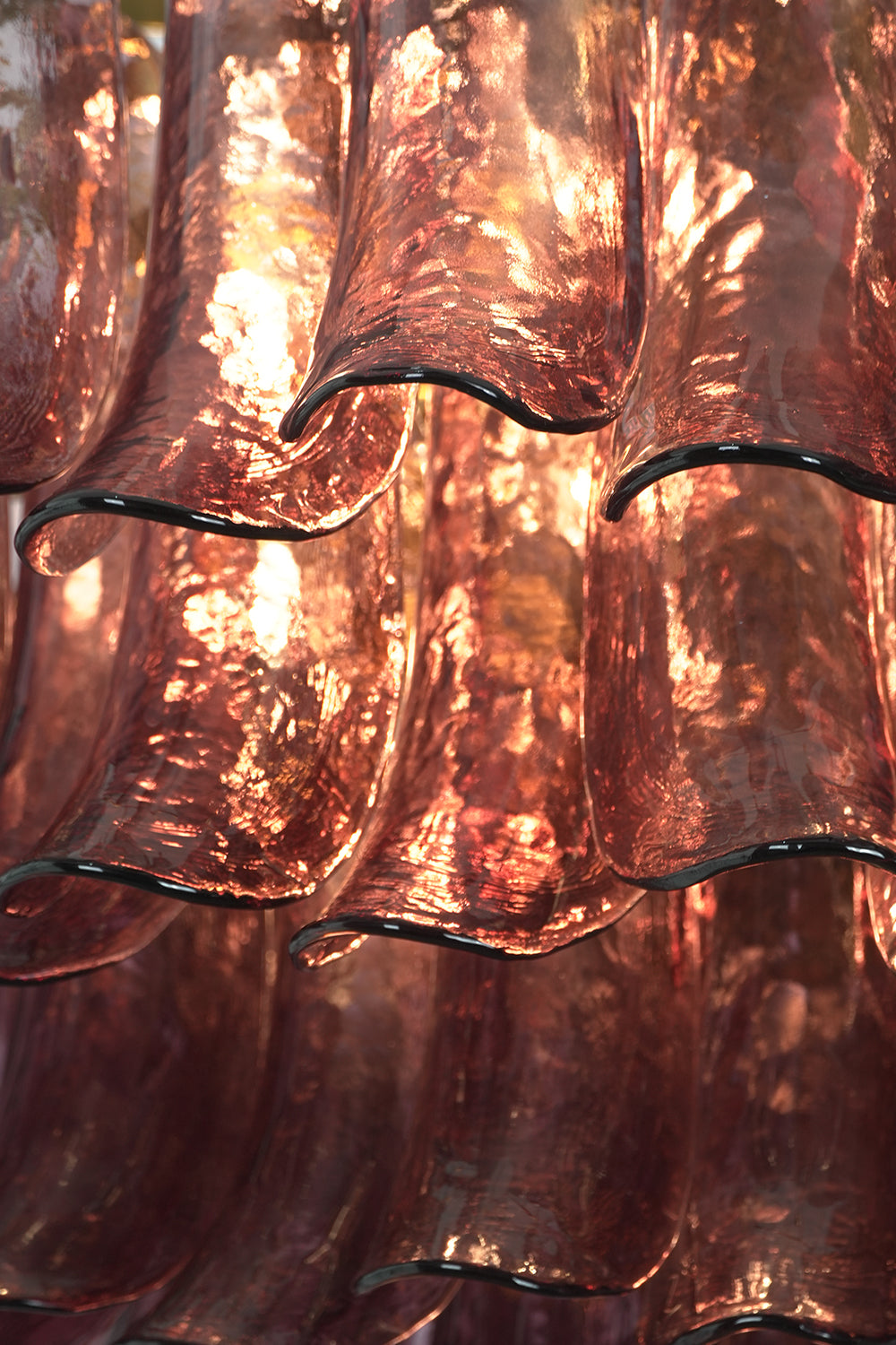 Regal Purple Cascade Chandelier | Glass, Metal | Close-up of the glowing purple glass petals with organic rippled texture | Detail shot | Samu Lamp
