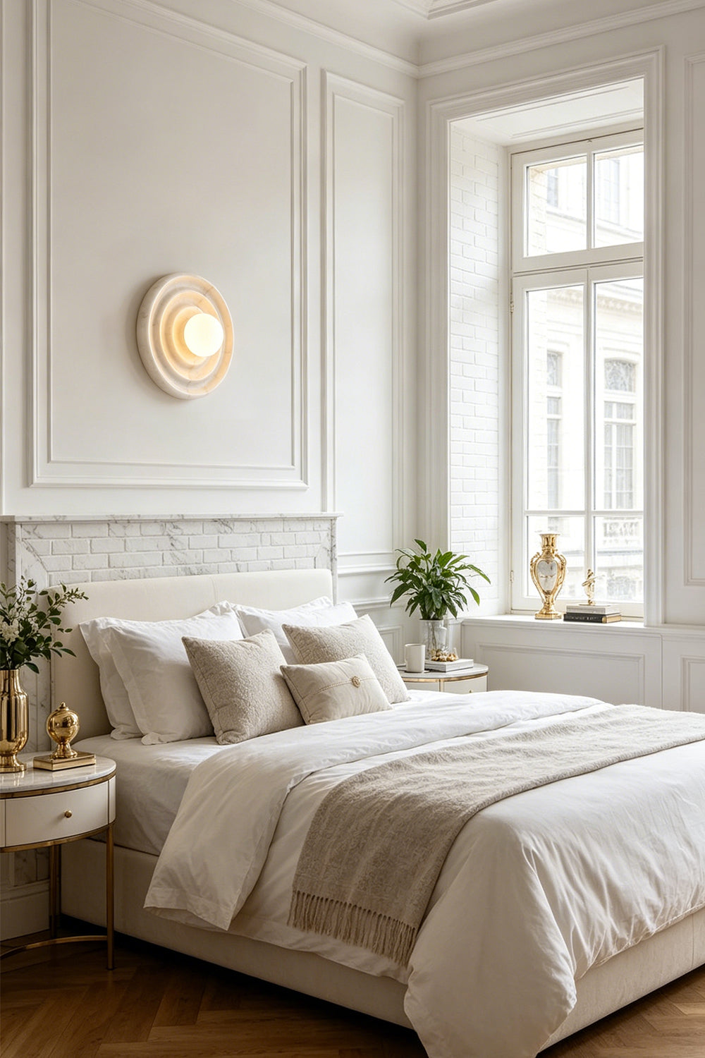 Rhea Rippled Alabaster Wall Sconce | Bedroom Bedside Light | Installed as a serene bedside wall sconce radiating a cozy golden light above an elegant platform bed with crisp white linens | Samu Lamp