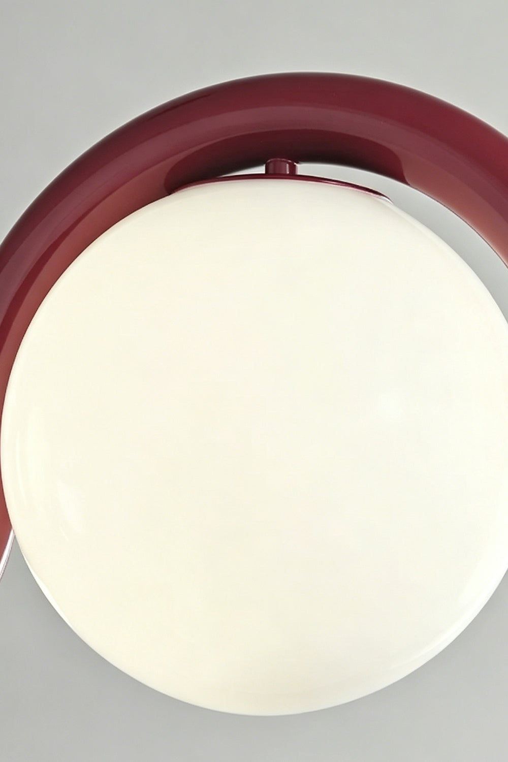 Close-up of the burgundy rhythmic flow pendant lamp | Metal, Glass | Focusing on the curved metal frame and opal glass | Samu Lamp