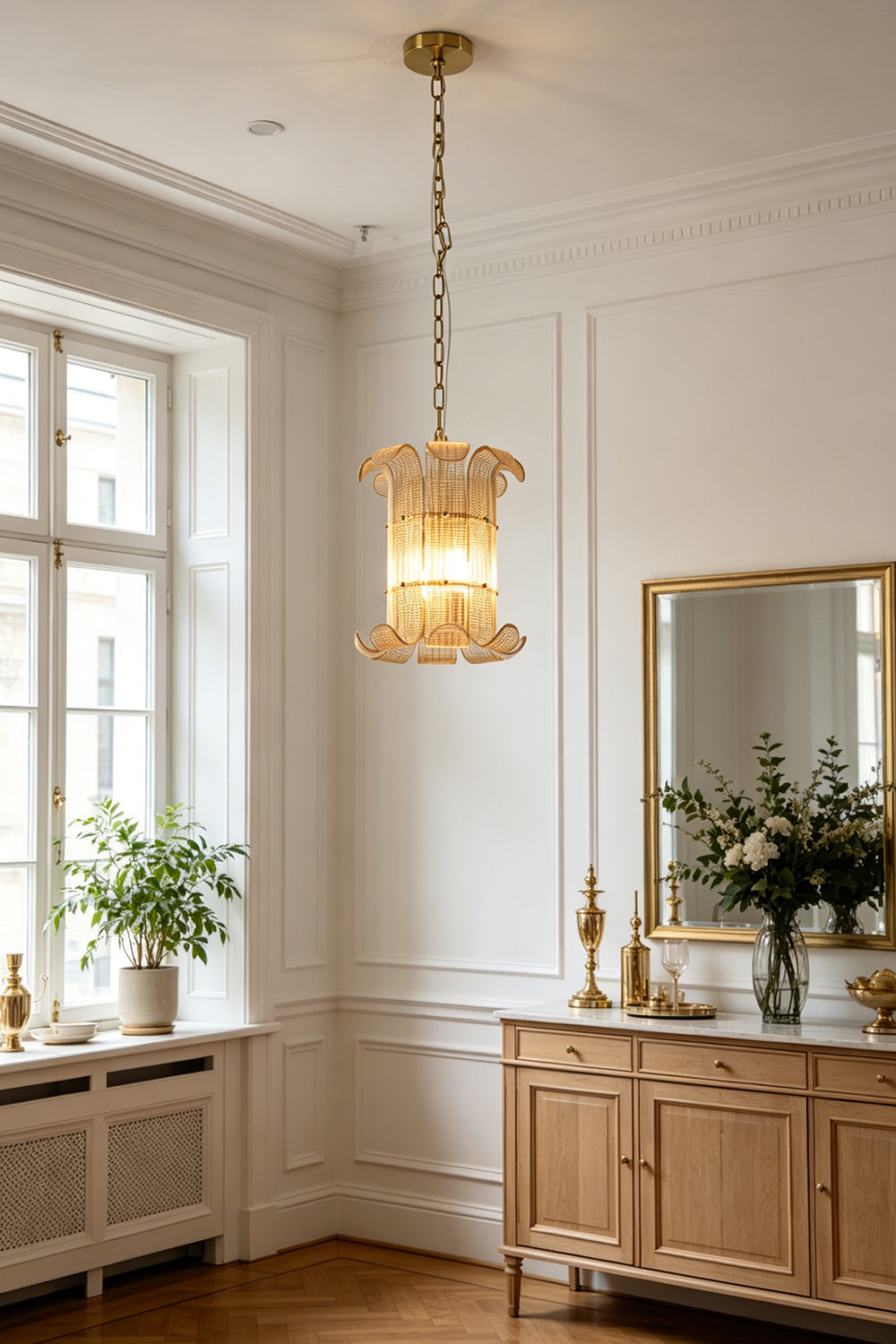 Elegant ribbed glass scroll chandelier | Metal | Glass | Installed in a bright traditional living room over a wooden cabinet | Samu Lamp