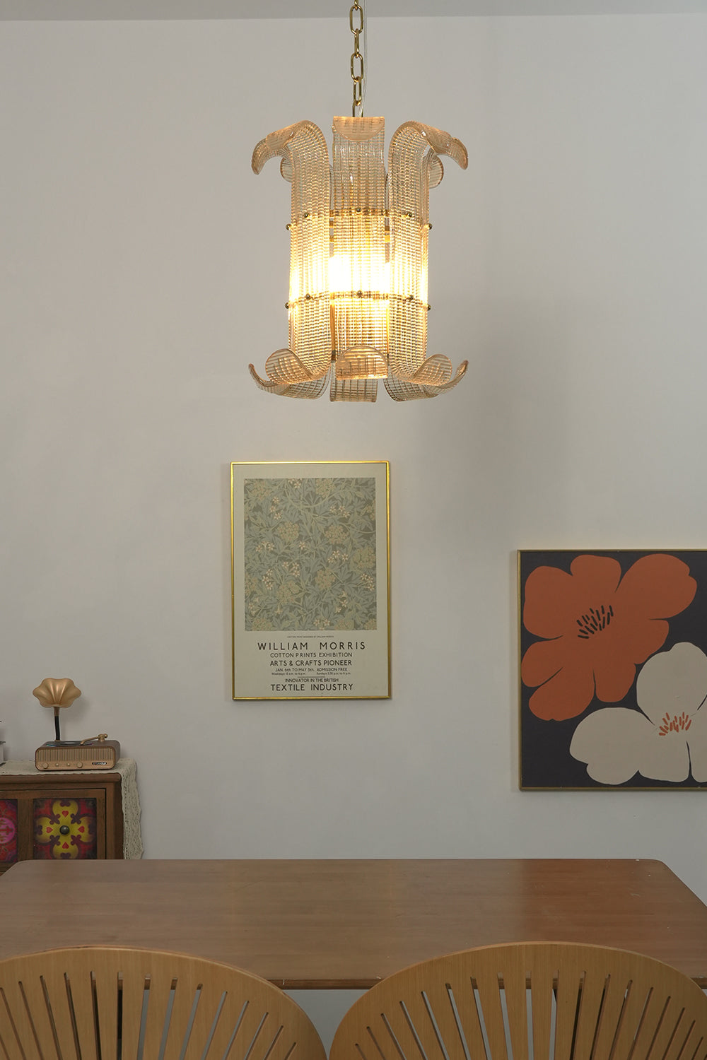 Ribbed glass scroll pendant lamp | Metal | Glass | Centered over a dining table with artistic wall decor | Samu Lamp