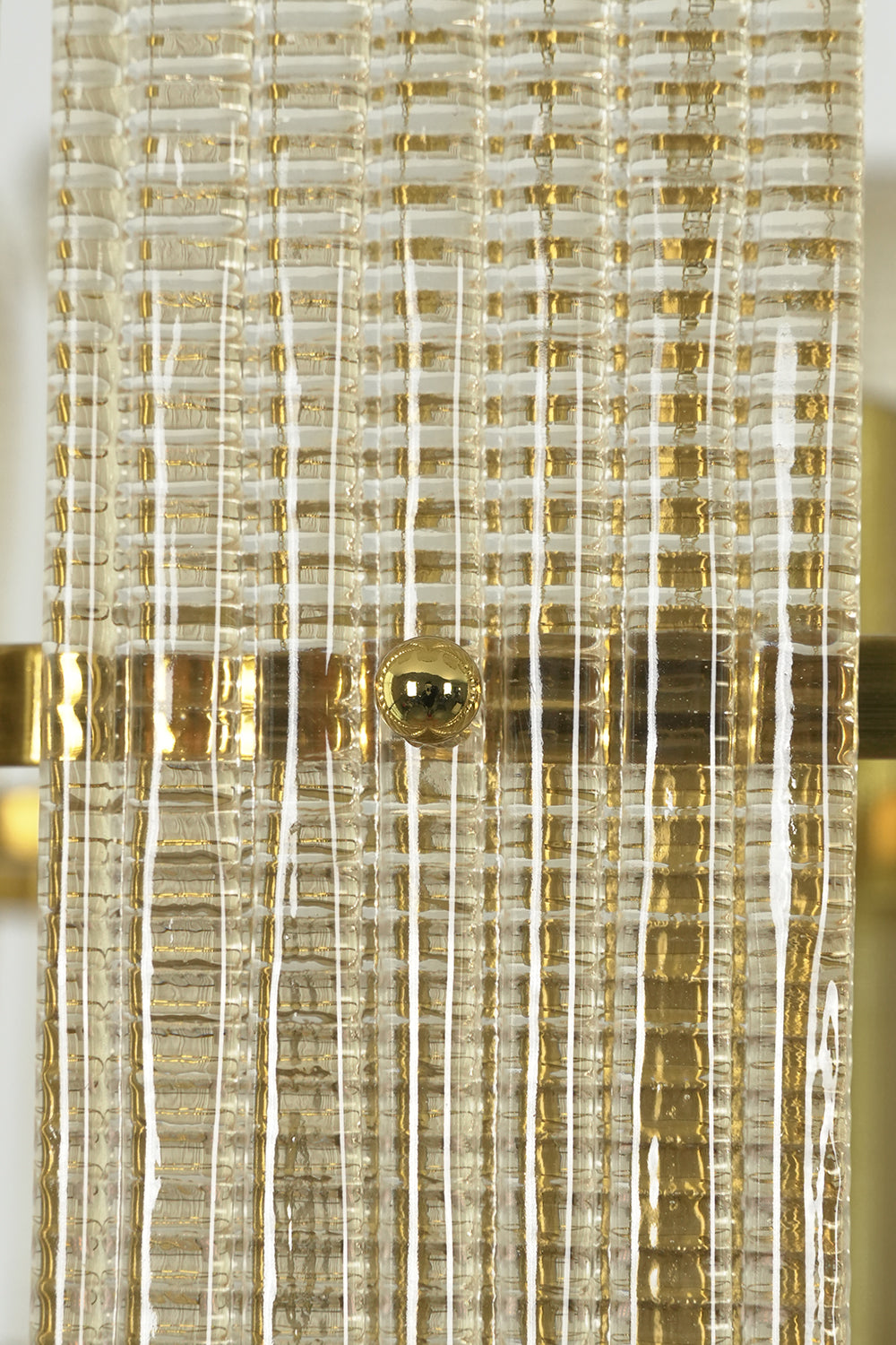 Close-up detail view of the ribbed glass texture | Glass | Showing the clarity and distinct scroll shape of the wall lamp | Samu Lamp