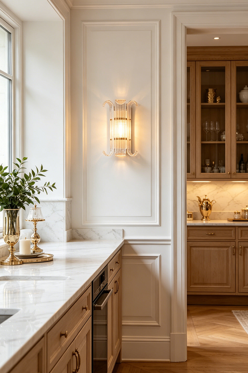 Ribbed Glass Scroll Wall Lamp in a bright kitchen space | Metal, Glass | Installed above white cabinetry and open shelving | Samu Lamp
