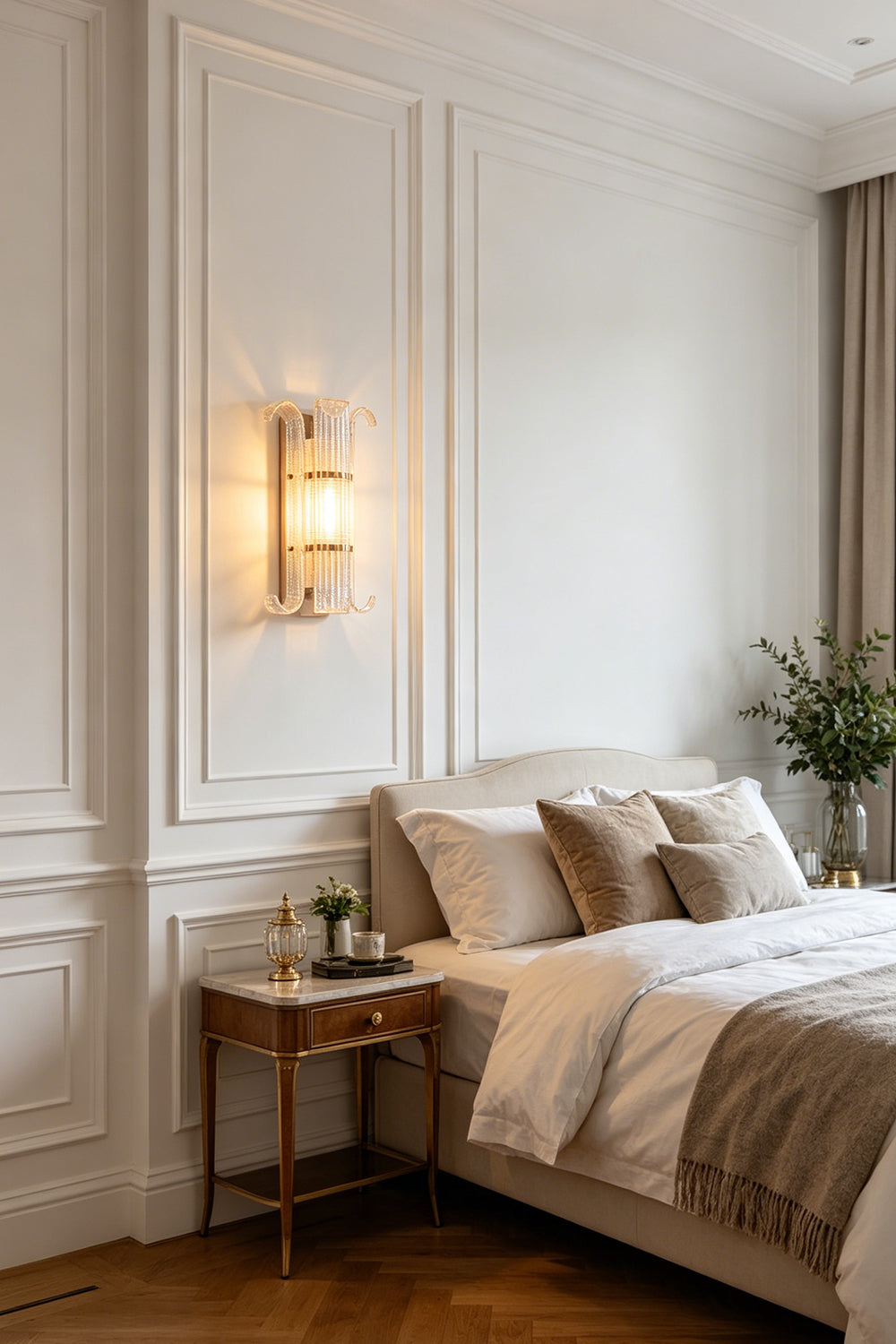 Ribbed Glass Scroll Wall Lamp providing warm bedside lighting | Metal, Glass | Installed above a queen bed with white bedding | Samu Lamp