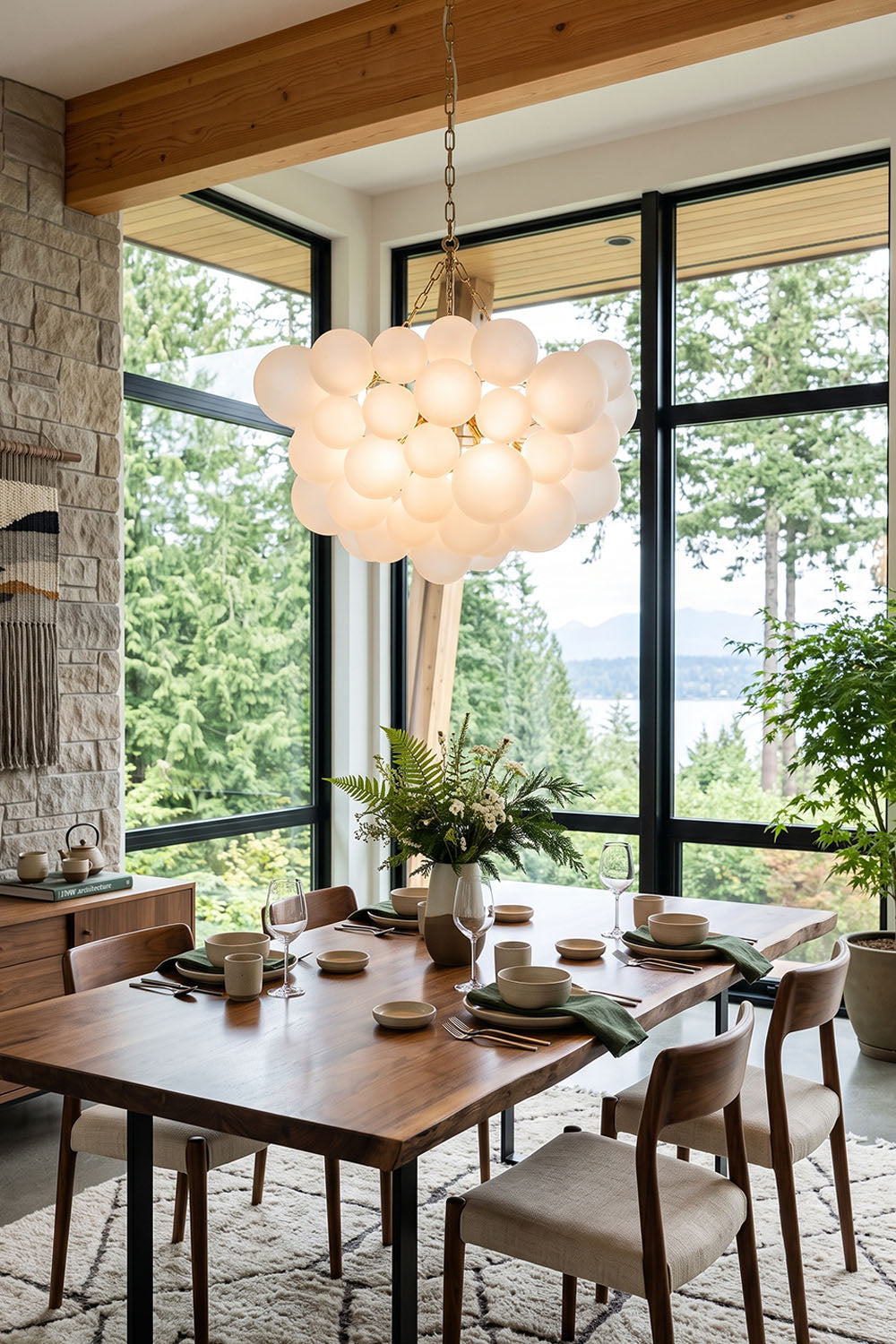 Romilly Frosted Globe Cluster Chandelier | Frosted Glass and Brass | Centered above a wooden dining table in a room with forest view windows | Samu Lamp