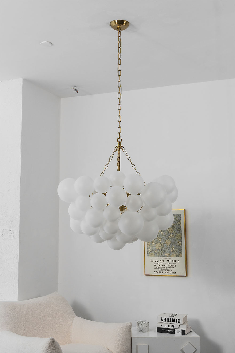 Romilly Frosted Globe Cluster Chandelier | Frosted Glass and Brass | Full room view showing the chandelier installed in a bright minimalist space | Samu Lamp
