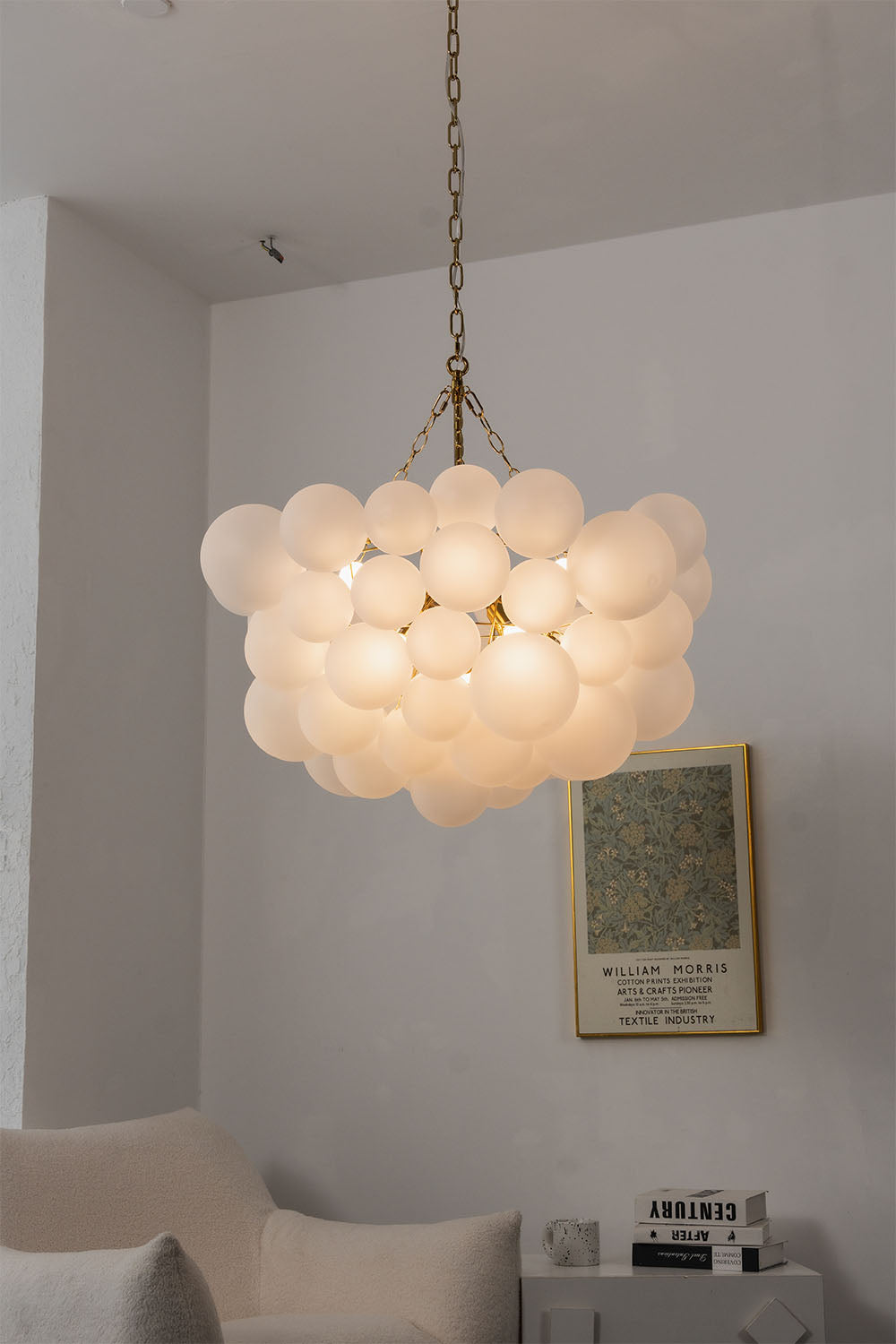 Romilly Frosted Globe Cluster Chandelier | Frosted Glass and Brass | Real-life installation view glowing softly in a simple room corner | Samu Lamp