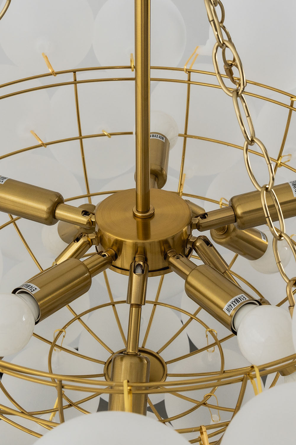 Romilly Frosted Globe Cluster Chandelier | Frosted Glass and Brass | Detail shot showing the bare internal brass skeleton frame and light sockets | Samu Lamp
