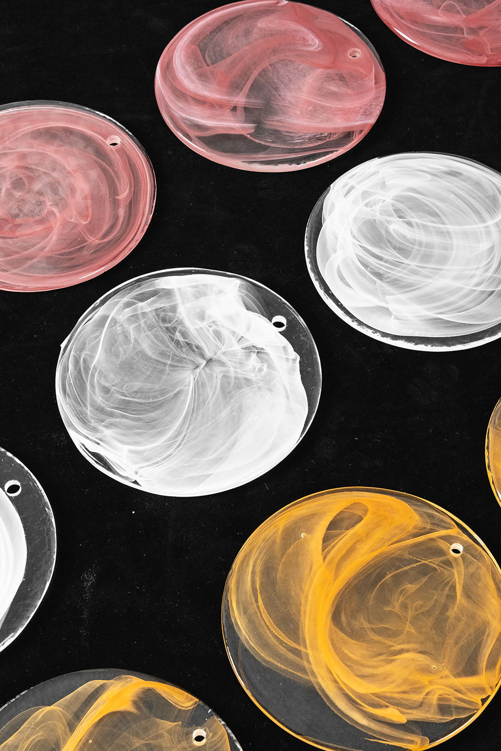 Romilly Layered Glass Disc Chandelier decorative glass discs in various colors on a black background.