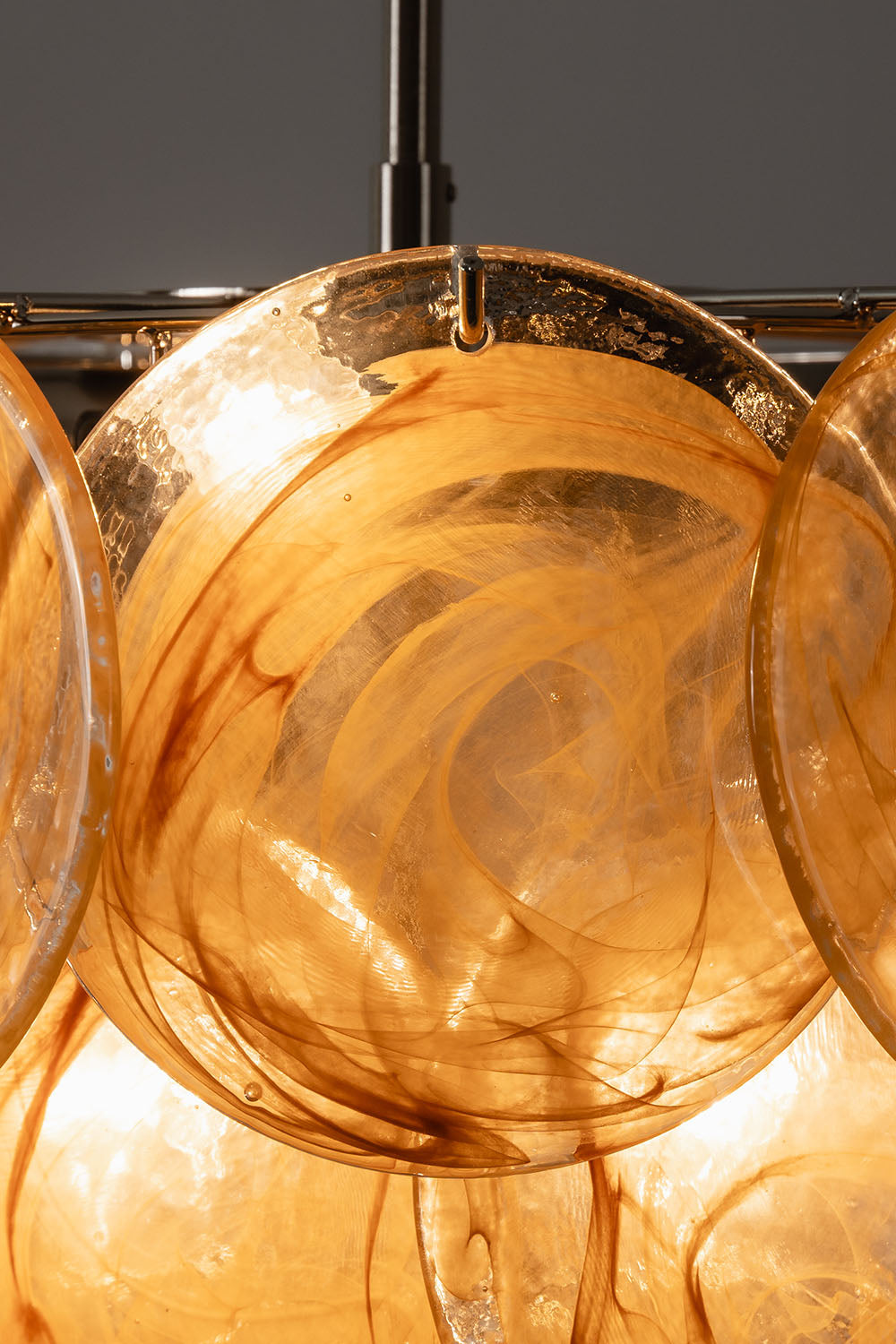 Romilly Layered Glass Disc Chandelier featuring intricate layered glass design with warm tones and elegant illumination.