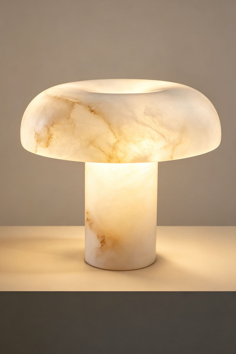 Rosalind Alabaster Dome Table Lamp | Natural Alabaster and Brass | Studio product view glowing brightly against a plain background | Samu Lamp
