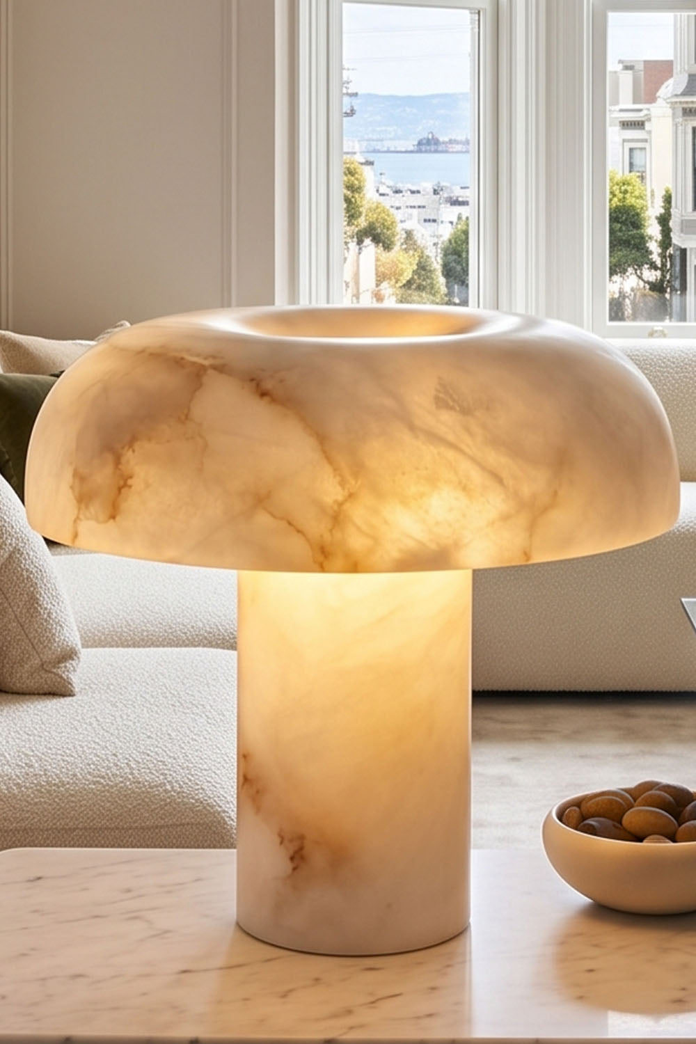 Rosalind Alabaster Dome Table Lamp | Natural Alabaster and Brass | Close-up view of the glowing stone lamp on a wooden table | Samu Lamp