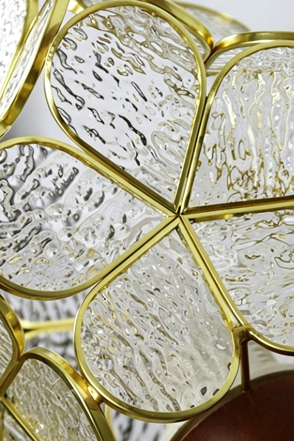 Rosalind Petal Glass Botanical Wall Lamp | Glass, Metal, Wood | Macro close-up view highlighting the detailed water-ripple texture of the glass panels secured inside the gold petal wireframe | Detail shot | Samu Lamp