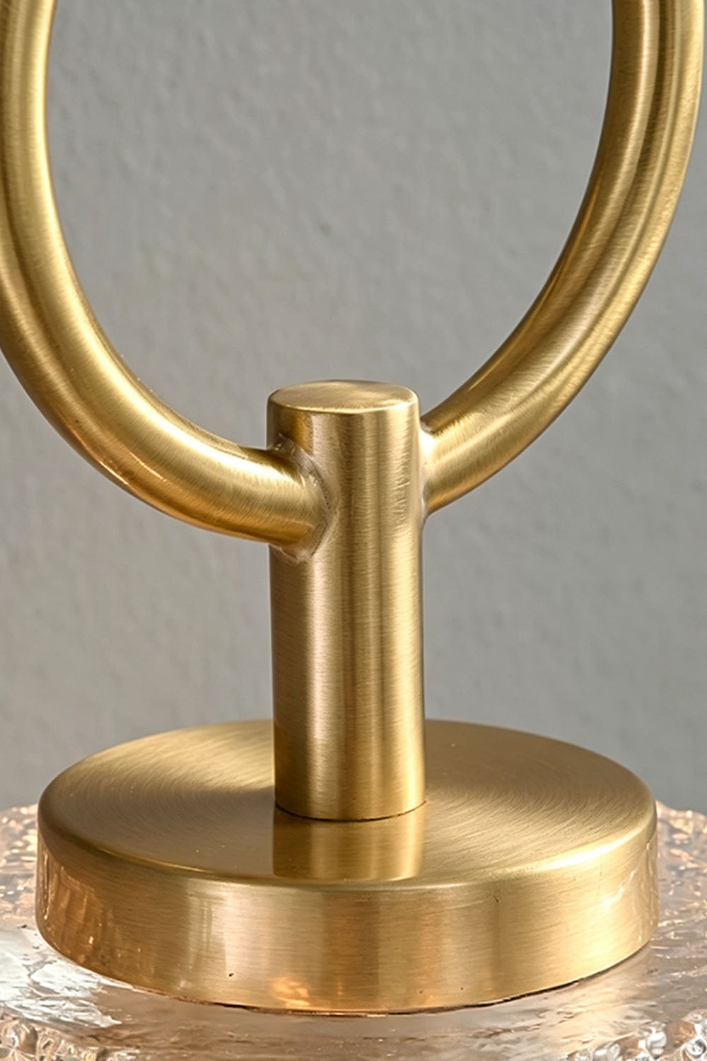 Rosamund Faceted Glass Wall Sconce | Faceted Glass and Brass | Macro close-up of the brass hanging ring and mounting hardware | Samu Lamp