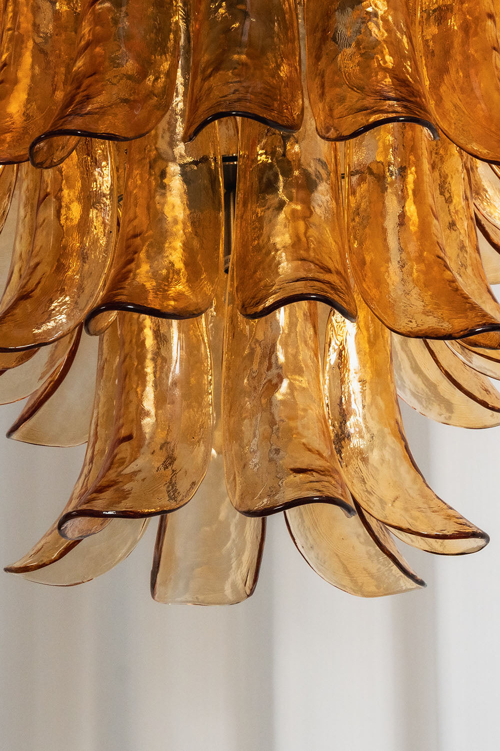 Rouveline Rippled Amber Glass Cone Chandelier | Rippled Amber Glass and Metal | Close-up view of cascading rippled amber glass cone elements | Samu Lamp