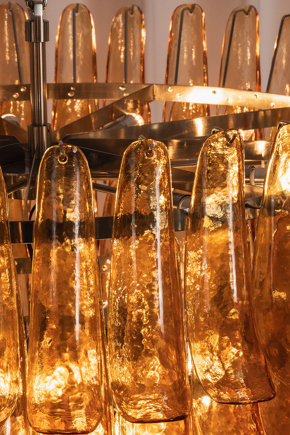 Rouveline Rippled Amber Glass Cone Chandelier | Rippled Amber Glass and Metal | Close-up detail showing internal metal frame and glass cones | Samu Lamp