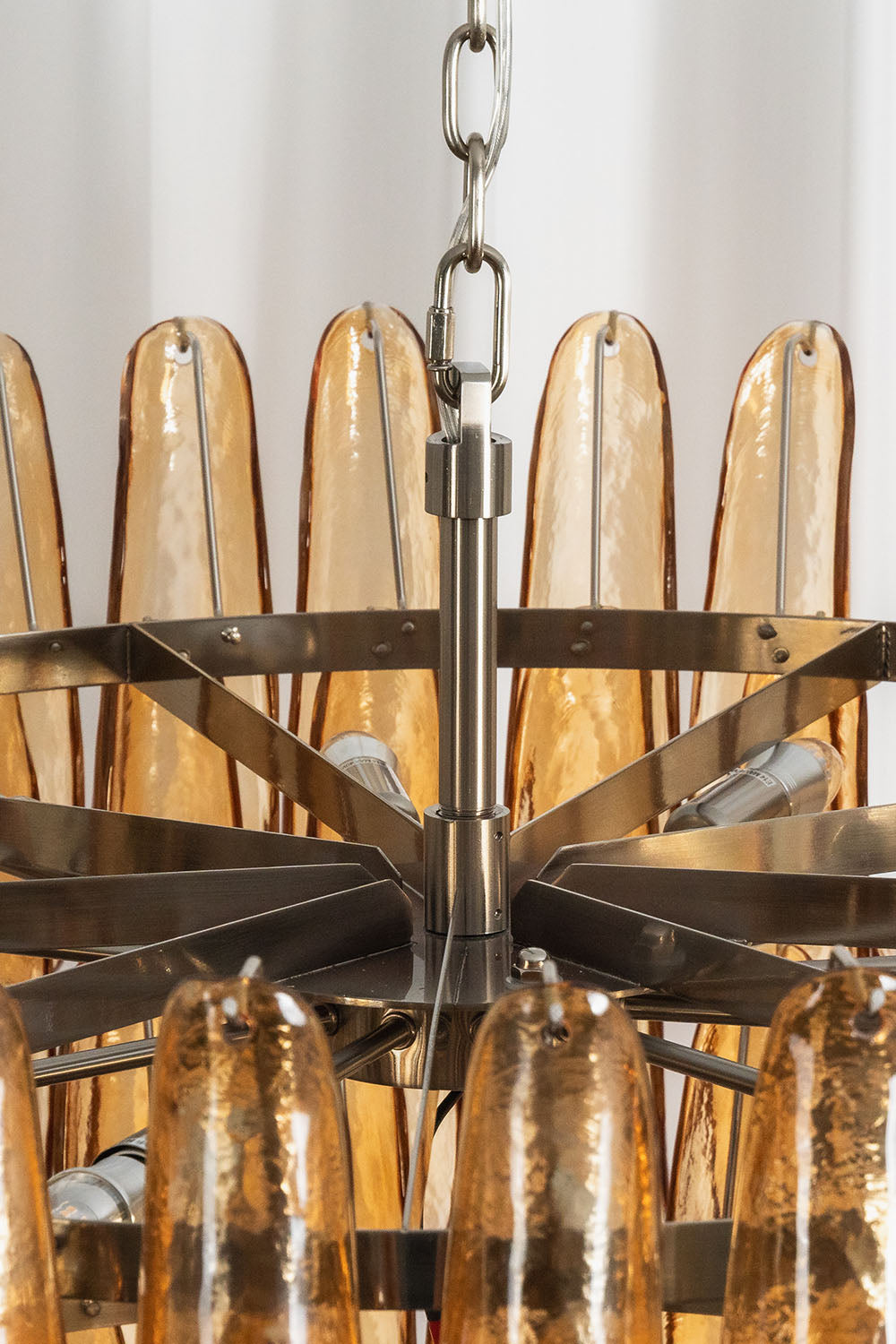 Rouveline Rippled Amber Glass Cone Chandelier | Rippled Amber Glass and Metal | Close-up view of the top hanging chain and metal ring frame | Samu Lamp
