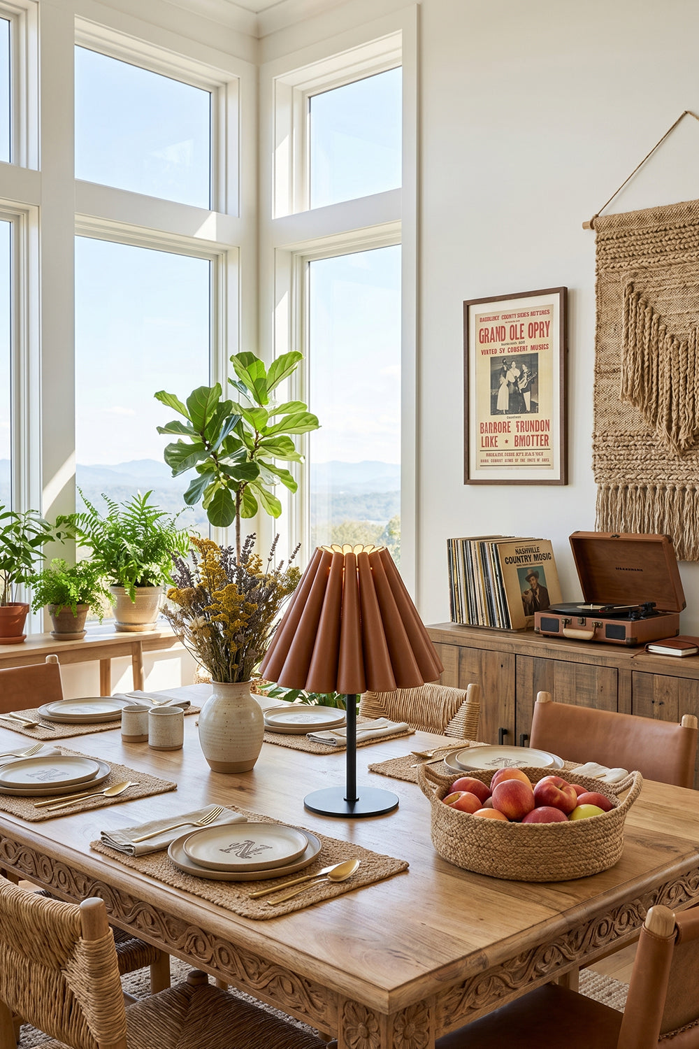 Rowan Leather Pleated Table Lamp | Leather, Metal | Serving as an elegant centerpiece on a long wooden dining table set in a sunlit corner dining room | Samu Lamp