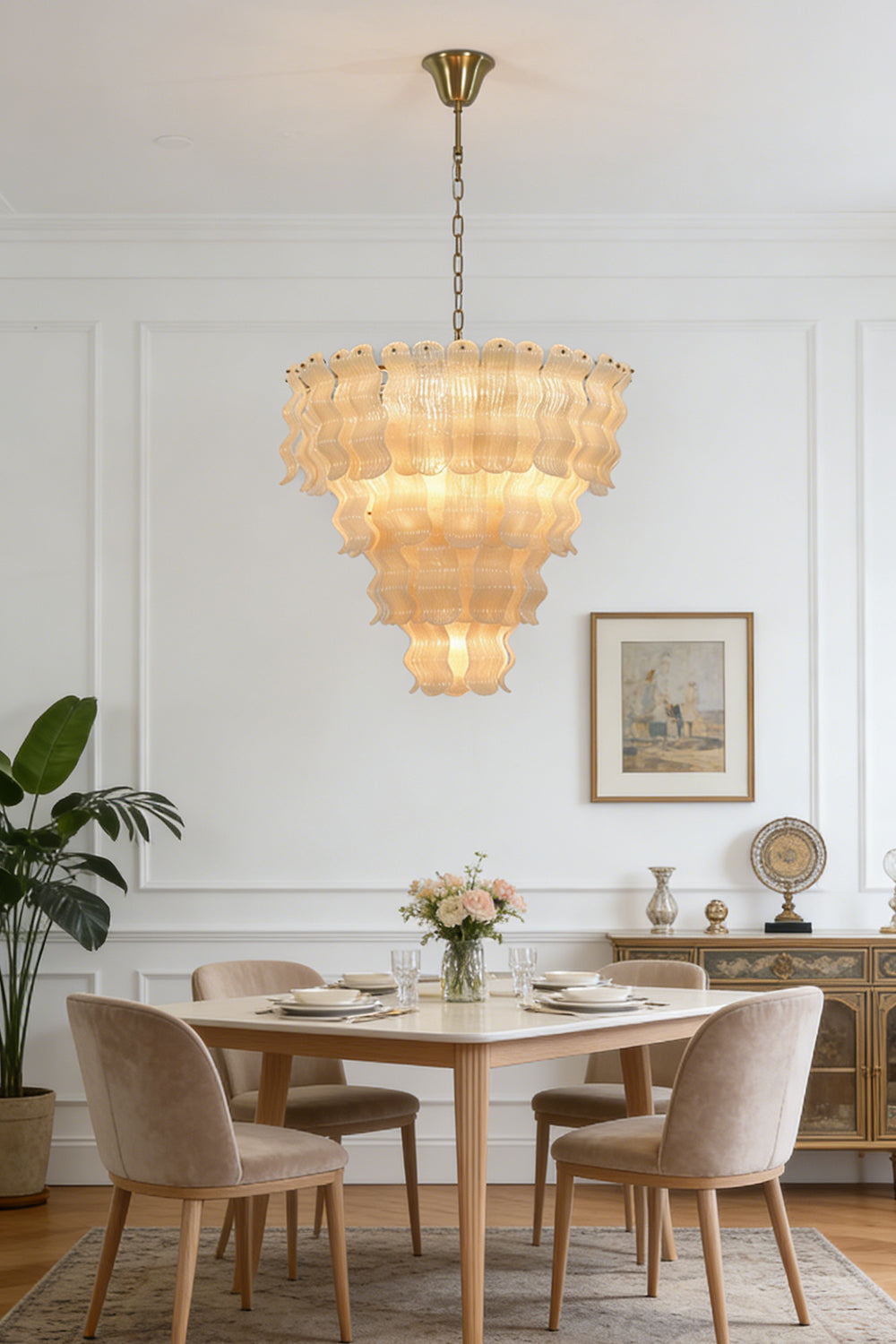 Ruffled glass chandelier for dining area | Metal | Glass | Installed over a small dining table with wooden chairs | Samu Lamp