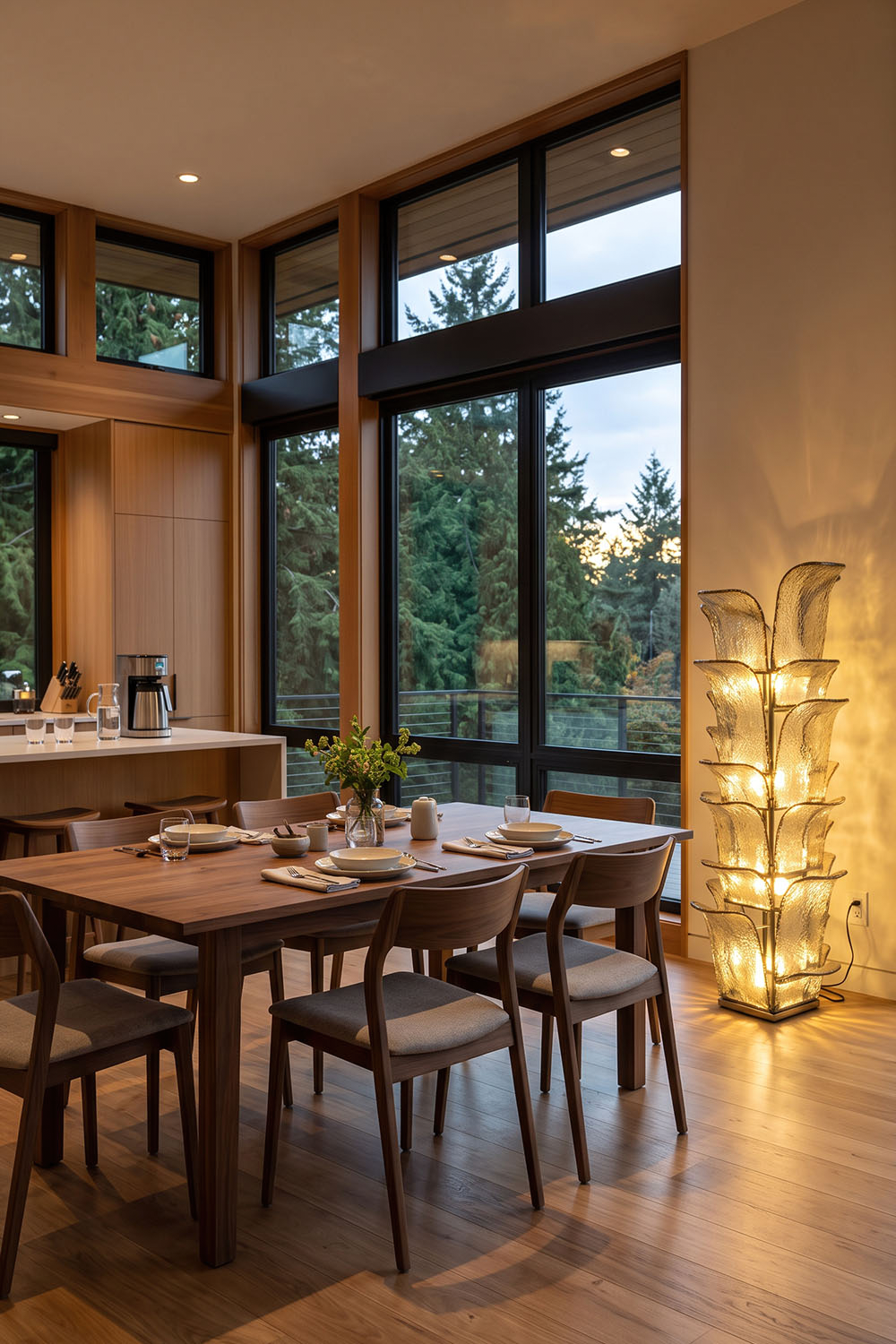 Saubrenne Glass Leaf Tiered Floor Lamp | Textured Glass and Brass | Illuminating a rustic dining room next to a long wooden table and forest window | Samu Lamp