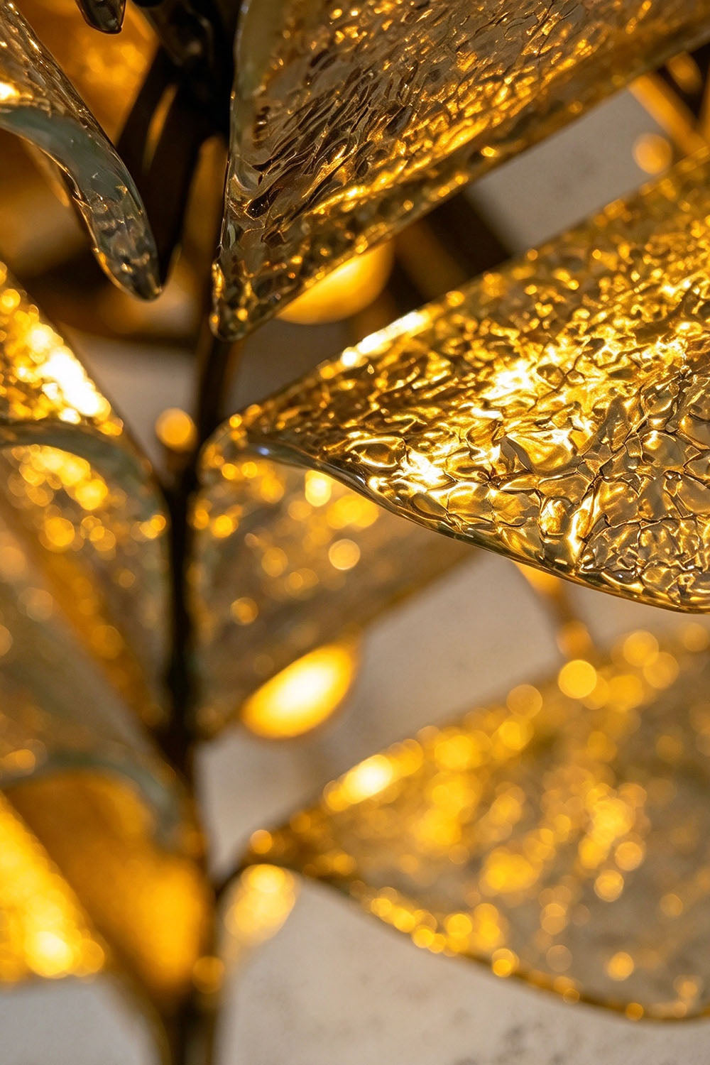 Saubrenne Glass Leaf Tiered Floor Lamp | Textured Glass and Brass | Angled close-up detail of illuminated glass leaf petals radiating warm light | Samu Lamp