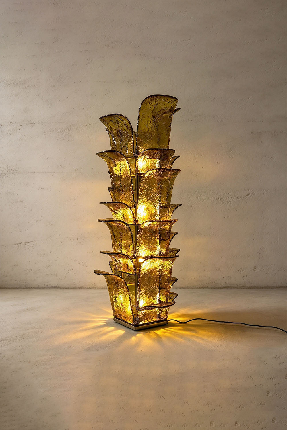 Saubrenne Glass Leaf Tiered Floor Lamp | Textured Glass and Brass | Full product view of the green glass leaf floor lamp glowing with warm light | Samu Lamp