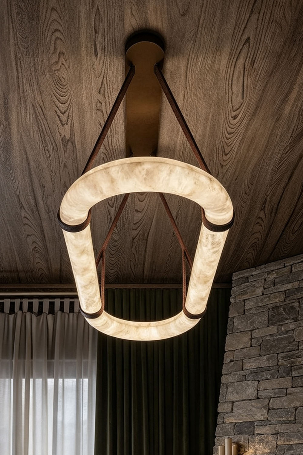Selwyn Racetrack Alabaster Leather Pendant Light | Natural Alabaster, Leather and Metal | Bottom-up perspective shot of the glowing oval alabaster ring | Samu Lamp