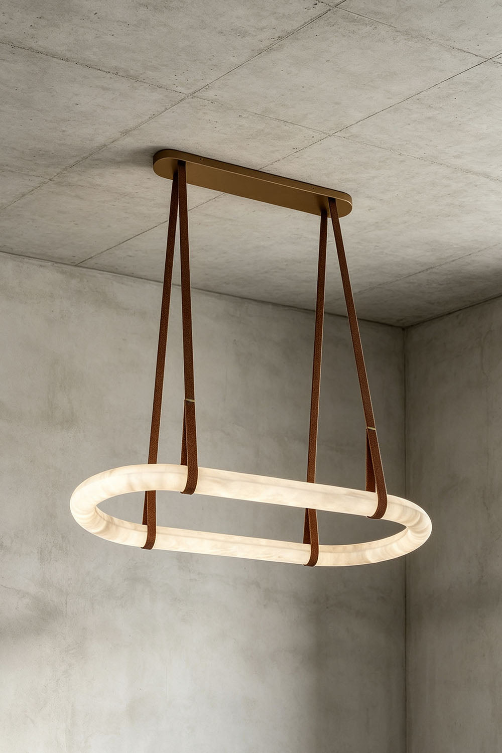 Selwyn Racetrack Alabaster Leather Pendant Light | Natural Alabaster, Leather and Metal | Angled illuminated view displayed against a concrete grey backdrop | Samu Lamp