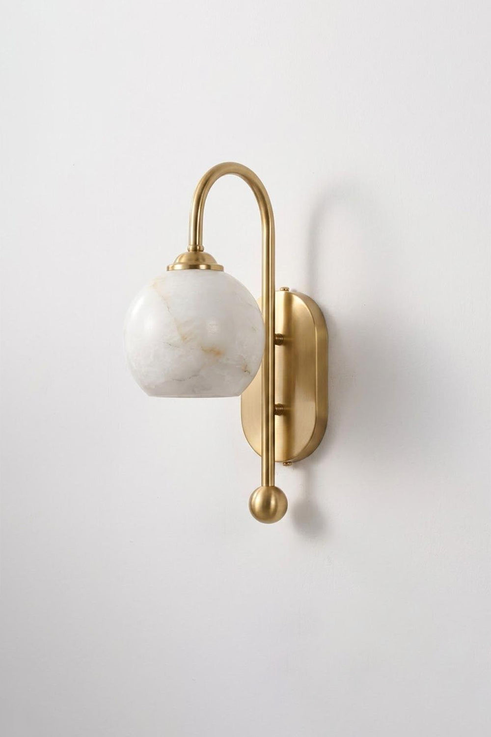 Seraphine Alabaster Globe Wall Sconce with gold-toned arm and hand-carved alabaster globe, ideal for accent lighting.