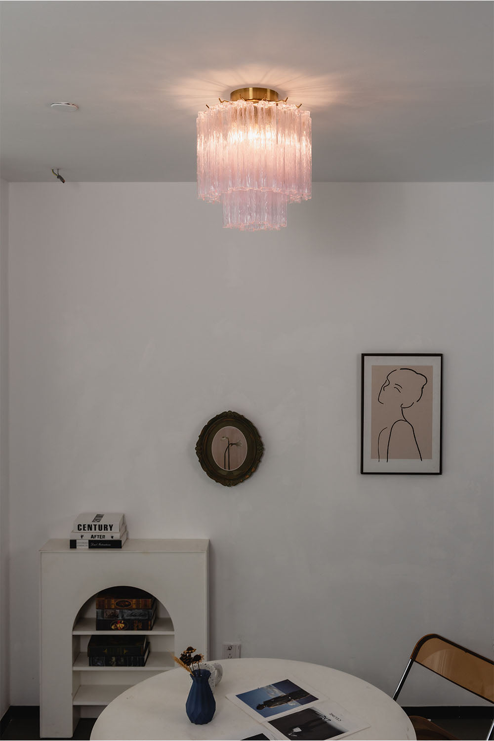 Seraphine Starburst Glass Tube Ceiling Light | Pink Glass and Brass | Glowing softly in a minimalist white dining room over a round table | Samu Lamp