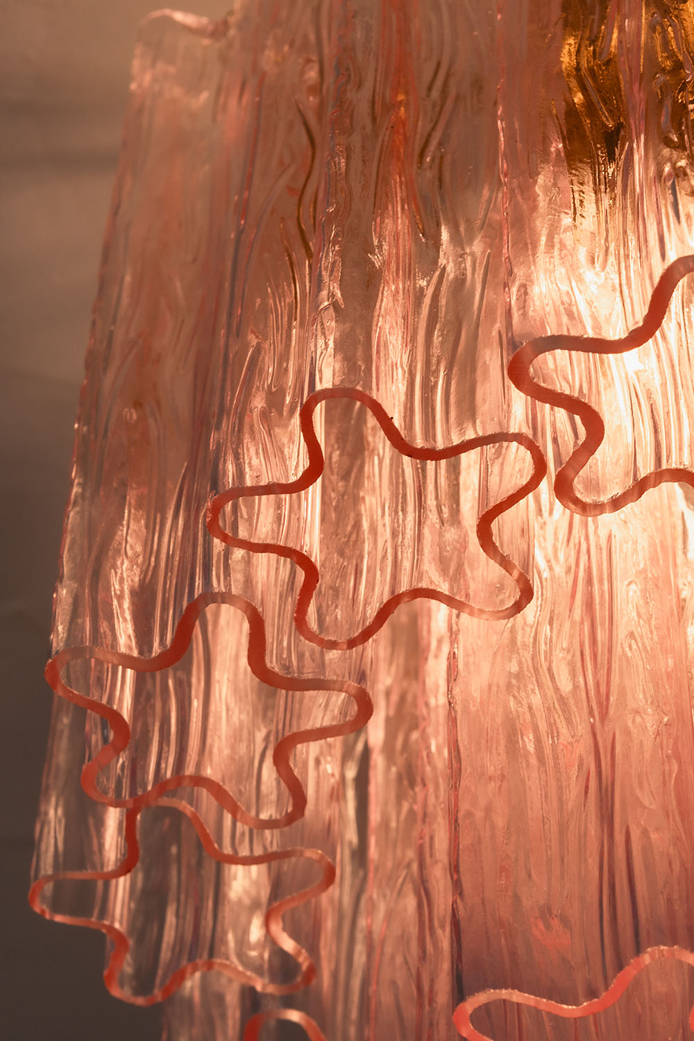 Seraphine Starburst Glass Tube Ceiling Light | Pink Glass and Brass | Medium close-up of the translucent pink starburst glass tubes | Samu Lamp