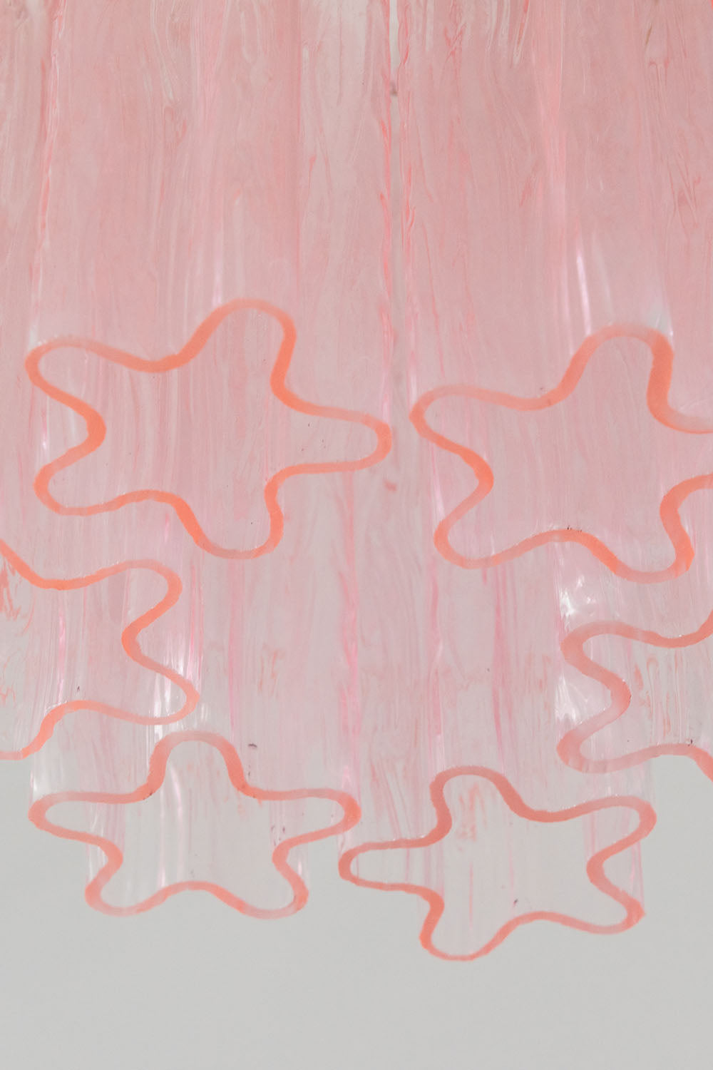 Seraphine Starburst Glass Tube Ceiling Light | Pink Glass and Brass | Detail shot highlighting the star-shaped profile of the pink glass tubes | Samu Lamp