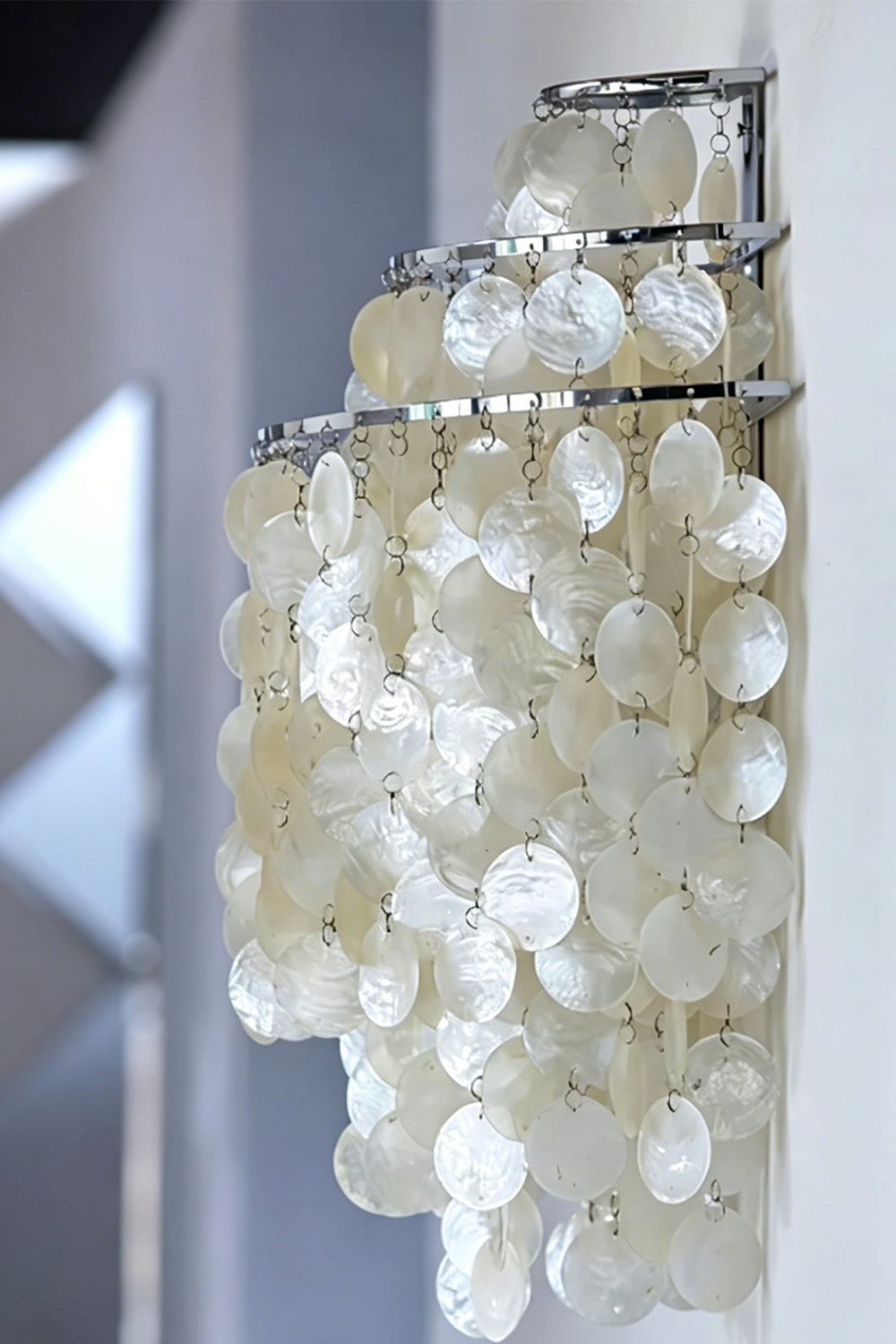 Side profile view of shell cascading light | Shell | Iron | Mounted on a wall showing the semi-circle layered shape | Samu Lamp