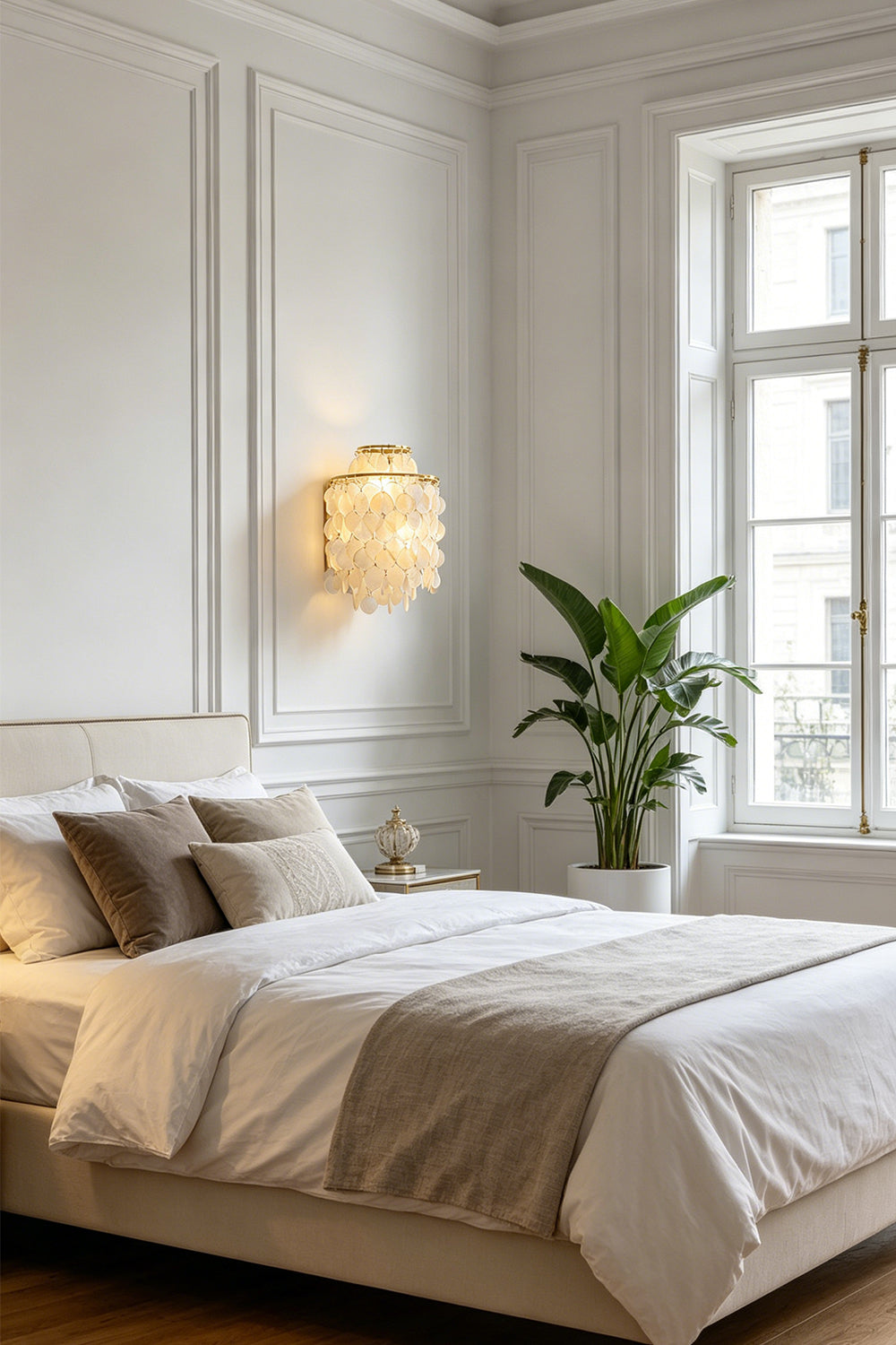 Serene shell cascading wall light | Shell | Iron | Mounted in a cozy bedroom above a white bed | Samu Lamp