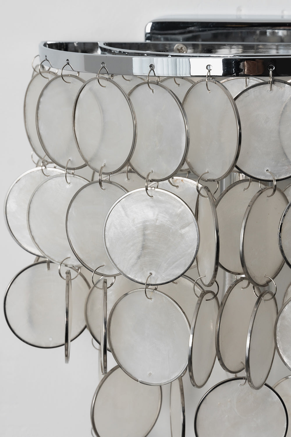 Detailed view of cascading Capiz shells | Shell | Iron | Close-up of metal rings and translucent shell discs | Samu Lamp