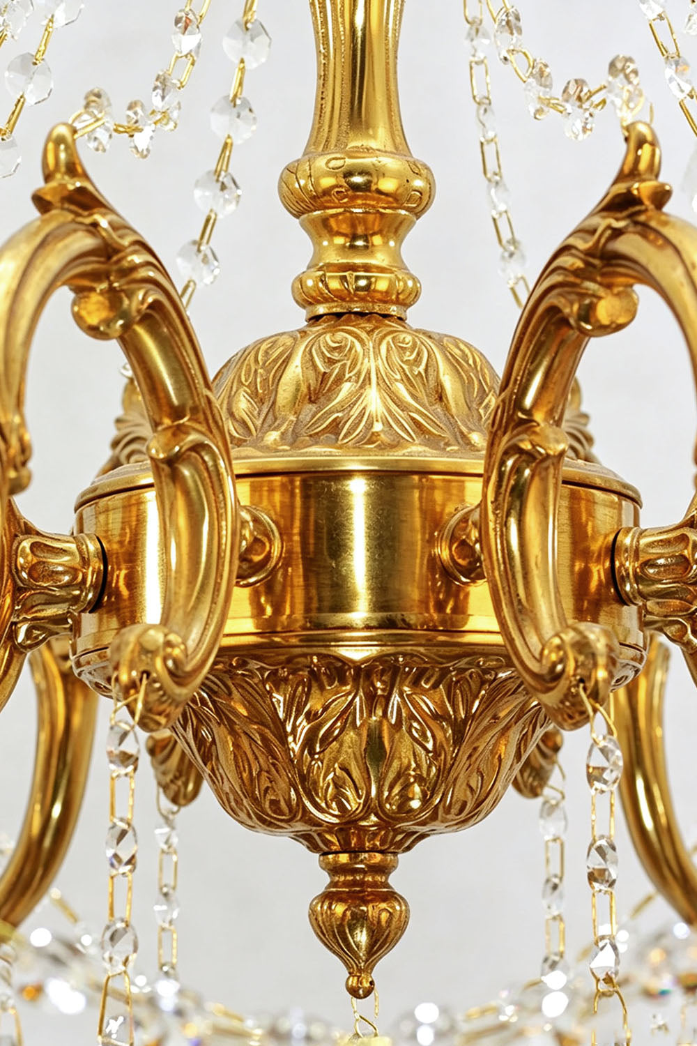 Close-up view of the intricate detailing on the Sidonie Scrolled Brass Crystal Chandelier, showcasing its elegant brass finish.