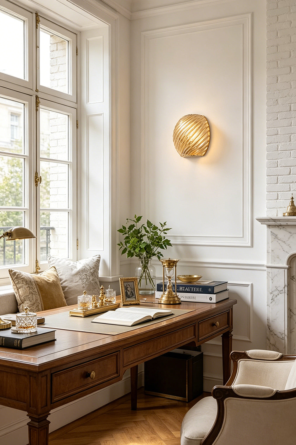 Silas Ribbed Glass Wall Sconce | Ribbed Glass, Metal | Mounted as an elegant amber gold accent light on a white wall above a classic wooden executive desk in a home office | Samu Lamp