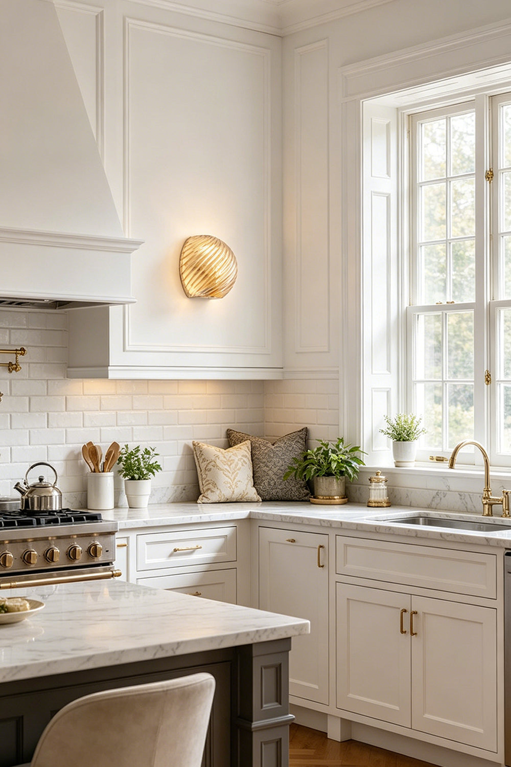 Silas Ribbed Glass Wall Sconce | Ribbed Glass, Metal | Illuminating a bright classical kitchen wall, casting a warm golden light halo near white cabinetry and marble counters | Samu Lamp