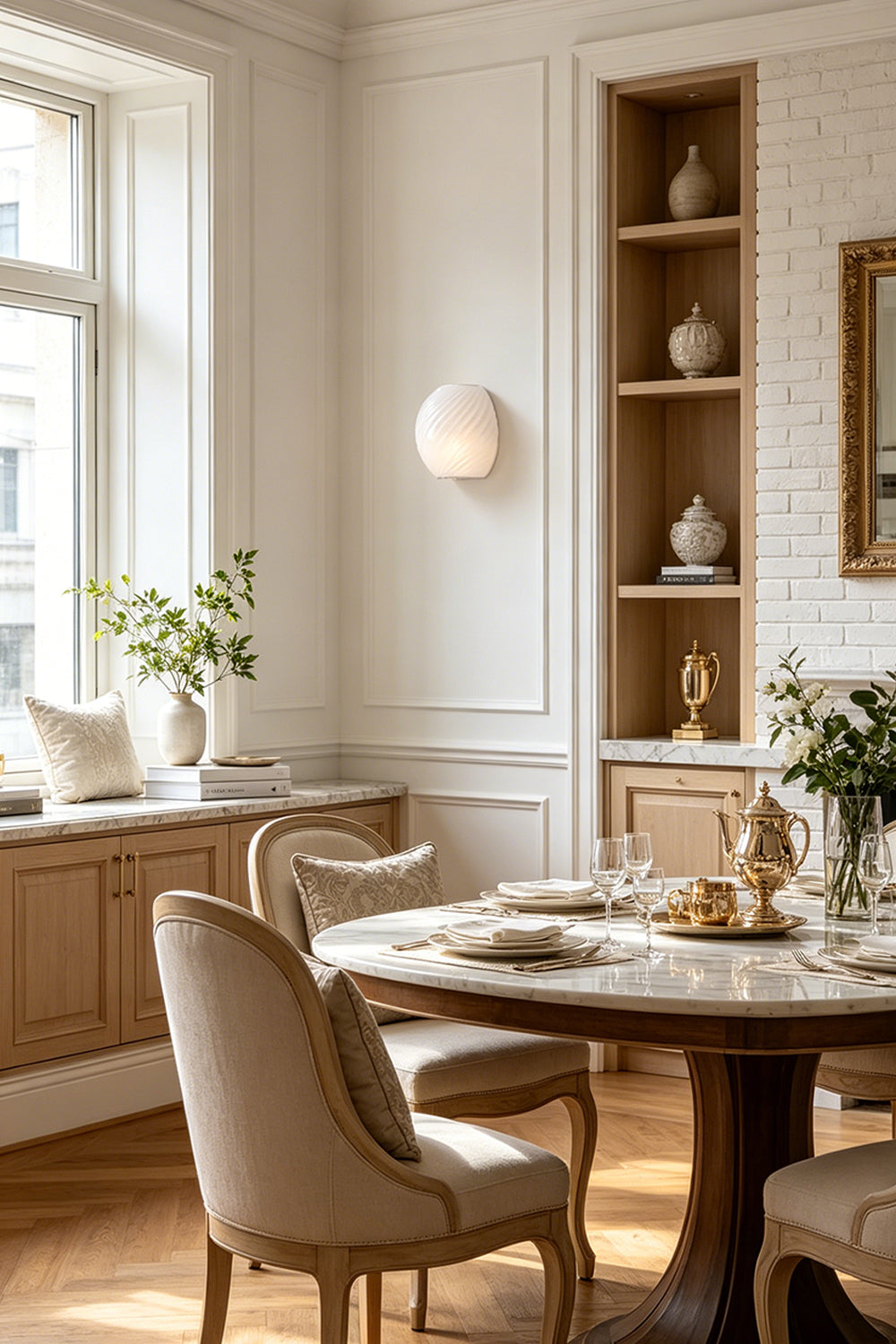 Silas Ribbed Glass Wall Sconce | Ribbed Glass, Metal | White frosted glass option staged on a wall in a bright dining area, casting a soft glow near a round wooden table | Samu Lamp