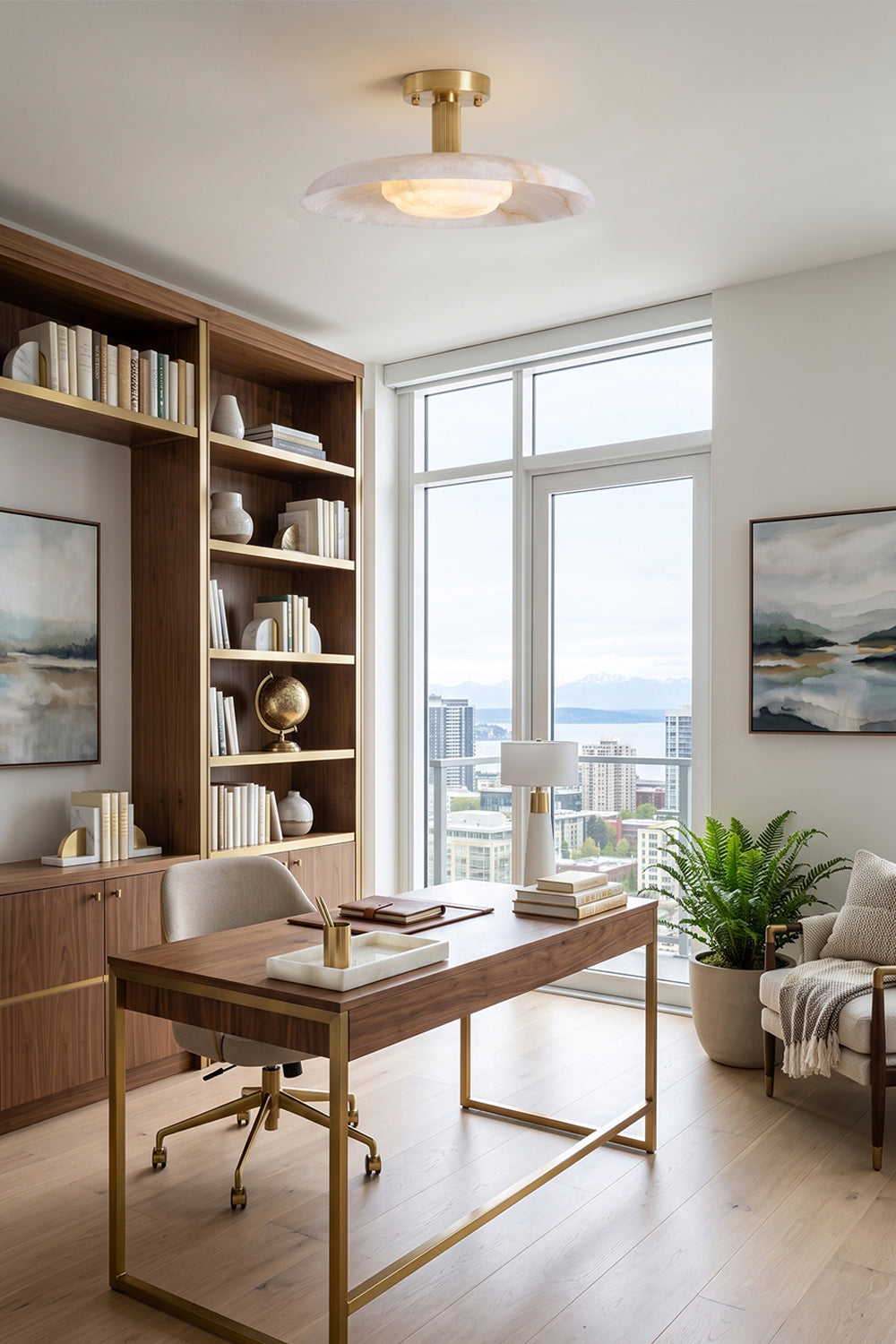 Solene Alabaster Round Ceiling Light | Study Room Light | Positioned gracefully as a main ceiling light fixture in a modern upscale home office with a sleek gold-framed desk and a tall bookcase wall | Samu Lamp
