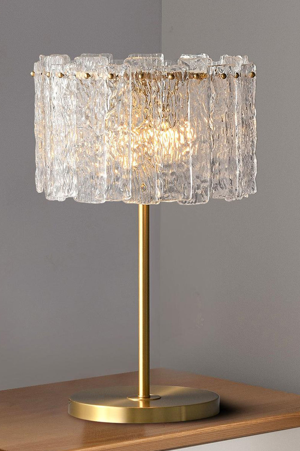 Solene Stacked Glass Table Lamp | Textured Glass and Brass | Placed on a side table next to a cream sofa in a living room | Samu Lamp