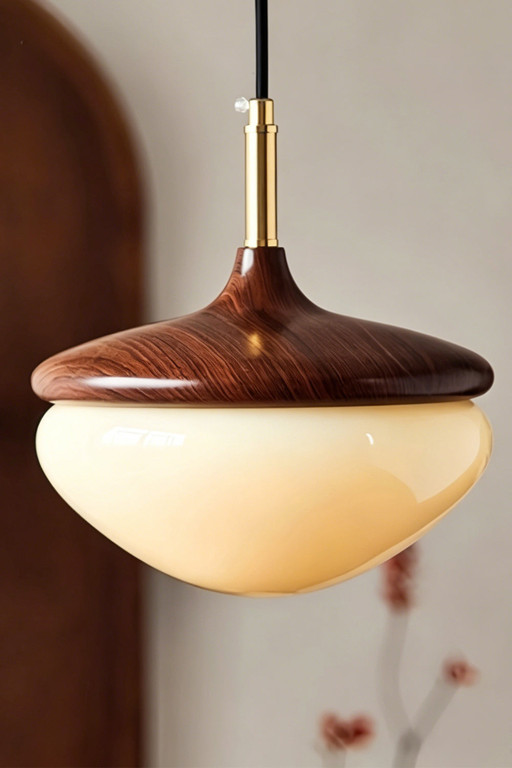 Soren Wood Grain Pendant Lamp | Wood, Glass, Metal | Detailed shot of the hanging mid-century pendant lamp illuminated against a warm neutral backdrop | Samu Lamp